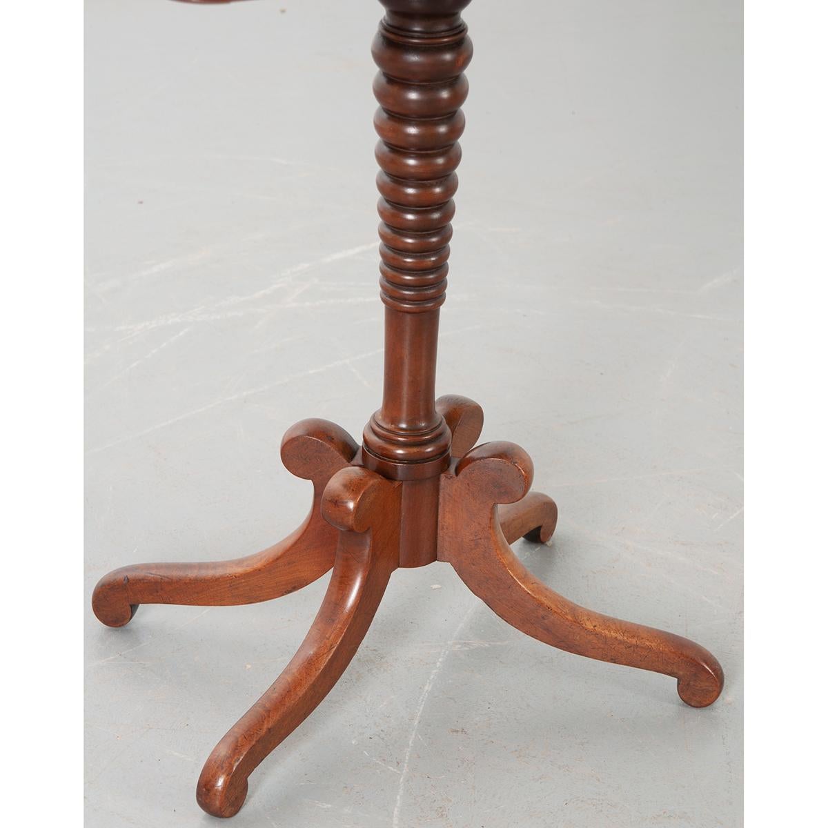 This is an English 19th century pedestal mahogany table. The top sits over an apron that conceals one drawer. All sit on a turned pedestal supported by four splayed legs. A pretty little table! Circa 1870.