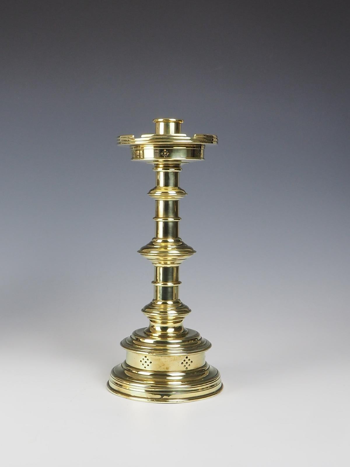 English 19th Century Pierced Brass Castellated Candle Holder, a stunning piece that exudes elegance and charm. Crafted during the 19th century, this candle holder showcases intricate pierced brass detailing, adding a touch of sophistication. The