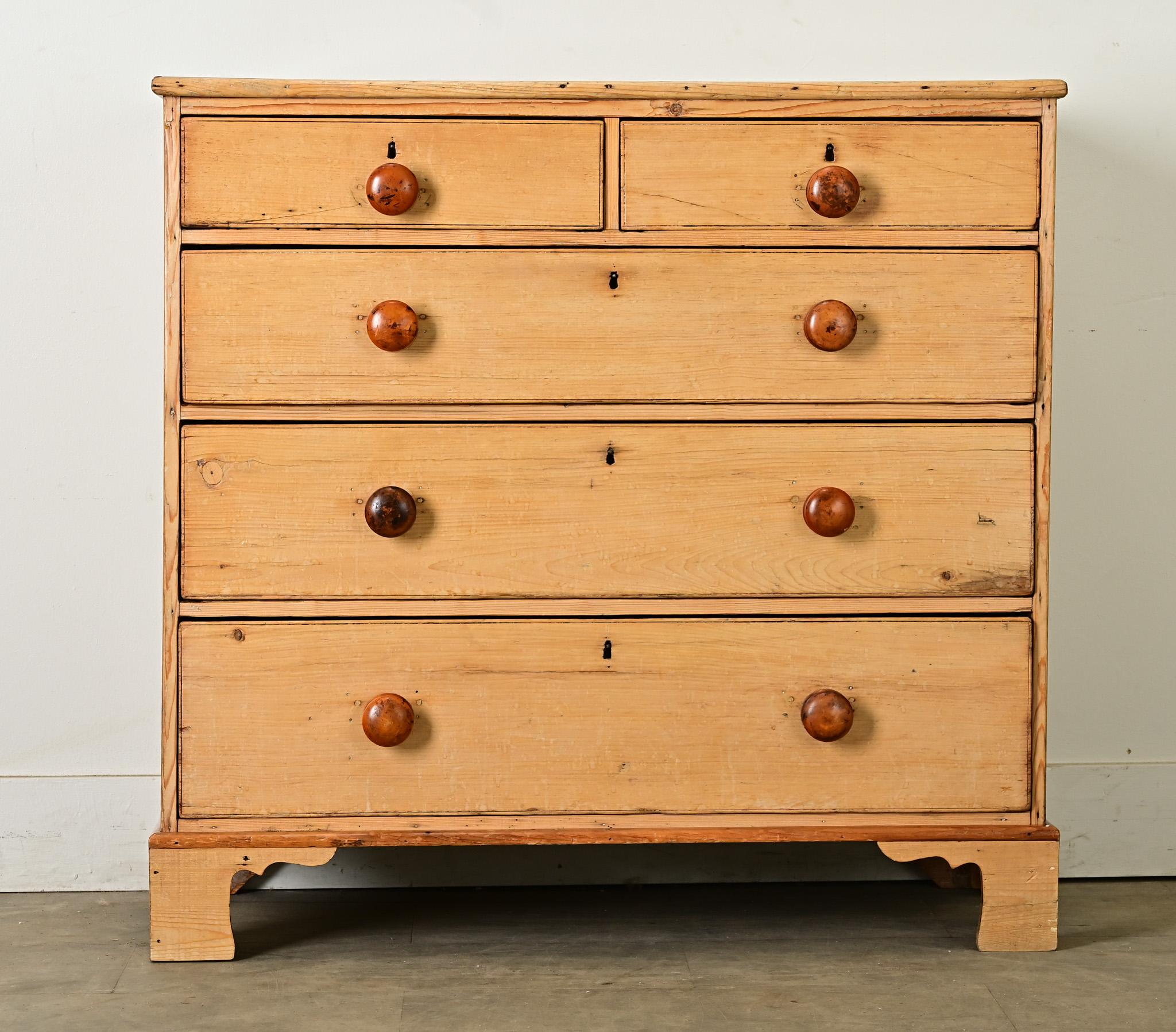 A lively natural blonde tone is an enchanting finish for this 19th century English solid pine chest of drawers. The antique has a total of five, easy-to-use drawers with two smaller drawers situated side by side over a bank of three graduated