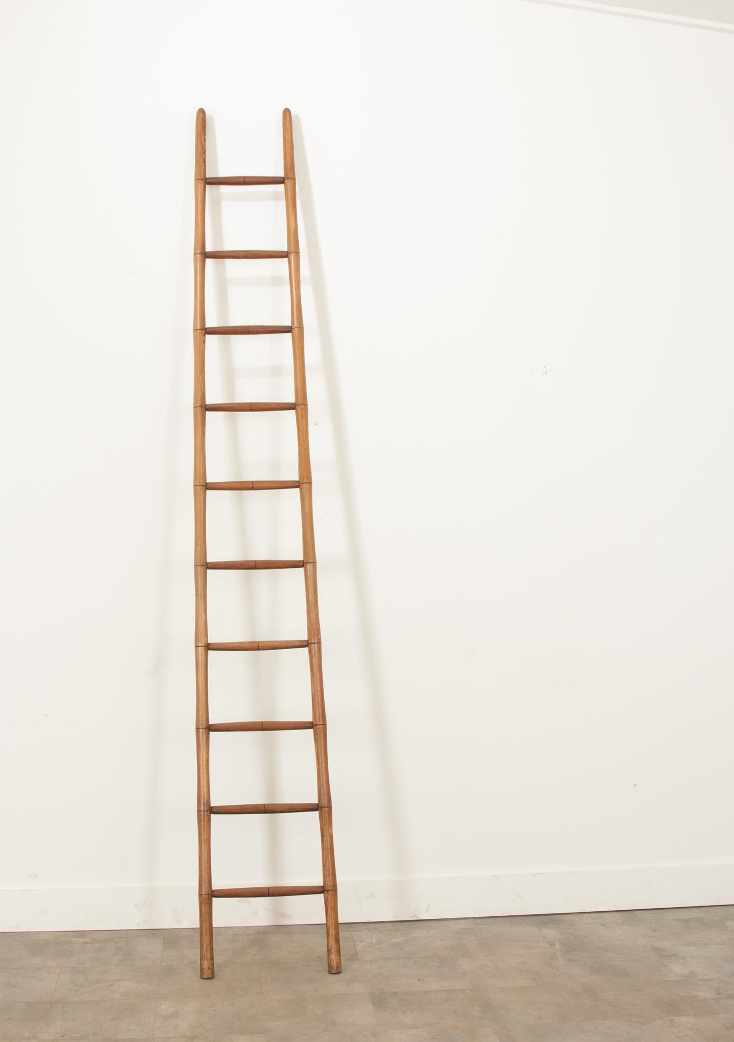This wonderful pine, faux bamboo kitchen ladder is a gorgeous accessory in any space. The vibrant hardwood has a fantastic patina from decades of use. Crafted in England during the 19th century, it's still functional as a ladder or an elegant way to