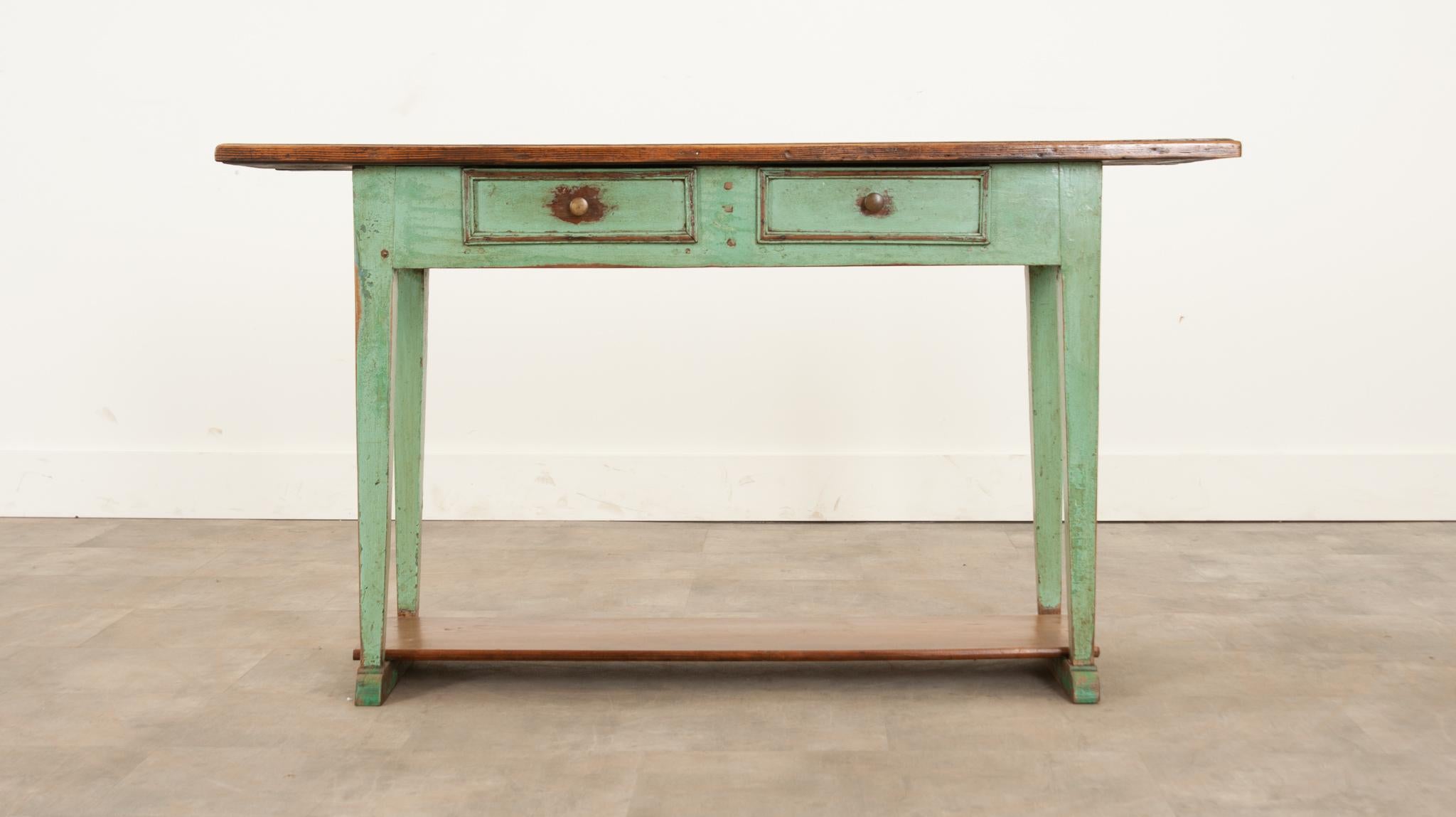 This 19th century English server is the perfect way to add a provincial pop of color to any space. The pine top showcases a beautiful patina and visible peg-in-hole joinery. Brightly painted in a sea foam green, the apron and legs have aged in just