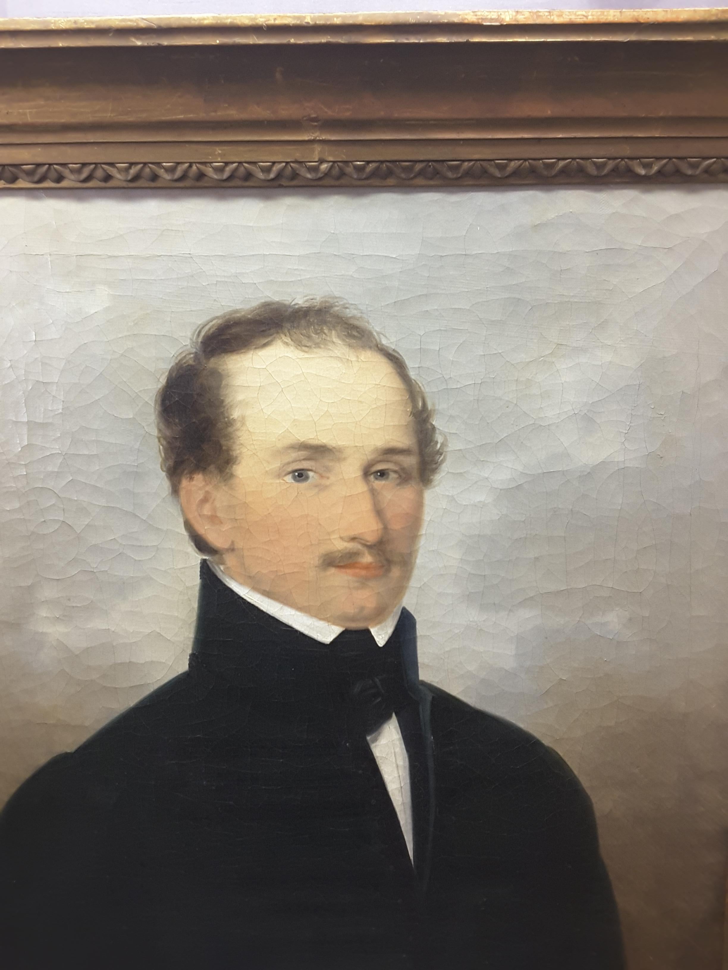 An English 19th century portrait of a gentleman, oil on canvas, original frame and stretcher, crackle paint typical of older paintings of this vintage. There is the remnants of an old gallery label only partial visible due to peeling, also has a