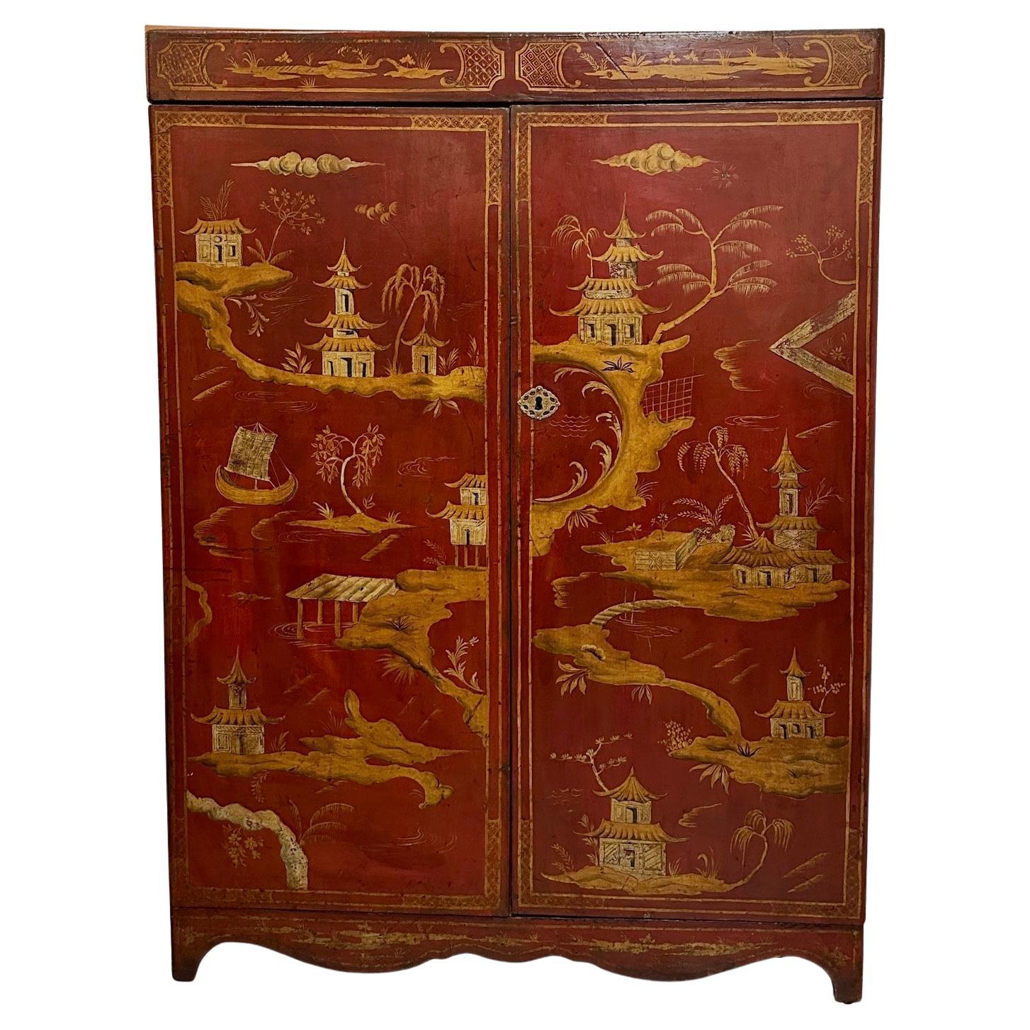 Beautiful English red lacquered armoire with hand-painted and gilded Chinoiserie decoration.  Finished on 3 sides and top. Gilded bronze escutcheon. Fitted with one shelf.  Cabinet partially lined with old, patterned paper.