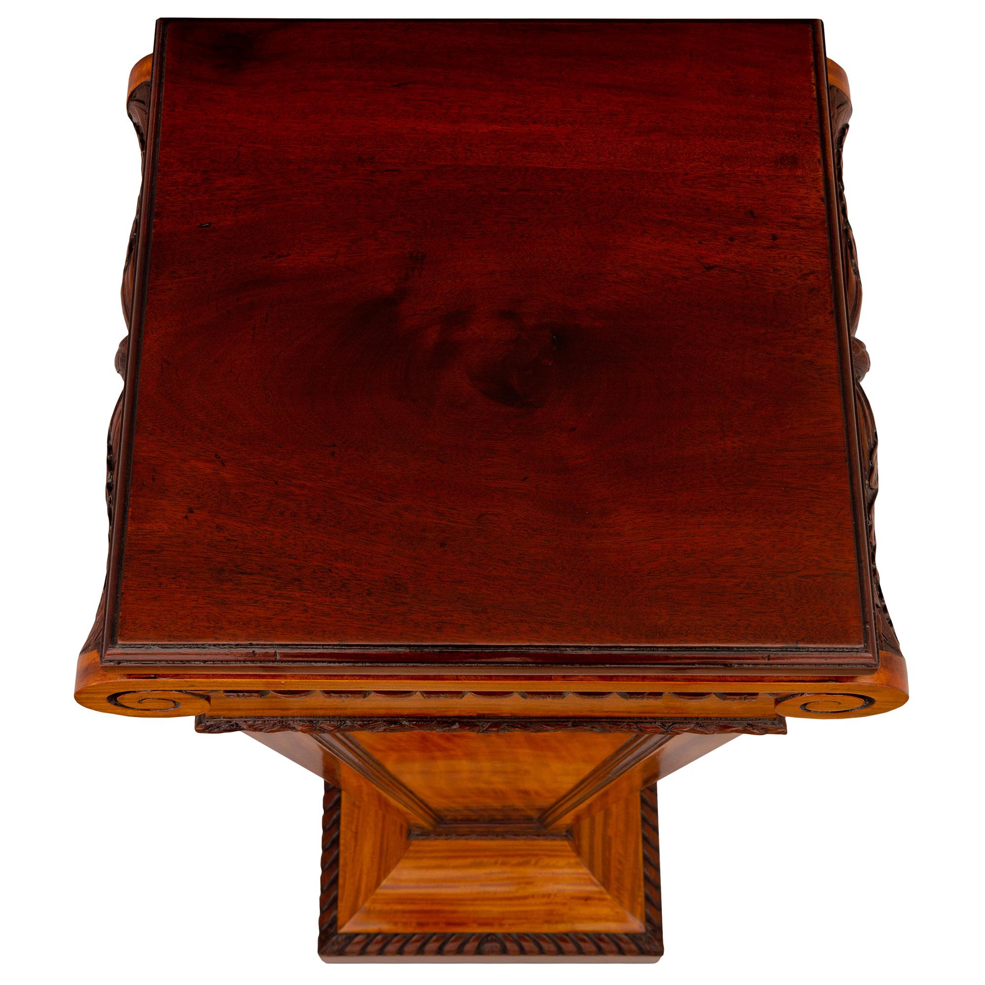 An elegant English 19th century Regency st. Satinwood pedestal column. The pedestal is raised by a square base with a finely carved wrap around gadroon design. Above the lightly curved socle shaped plinth is the square tapered central support with
