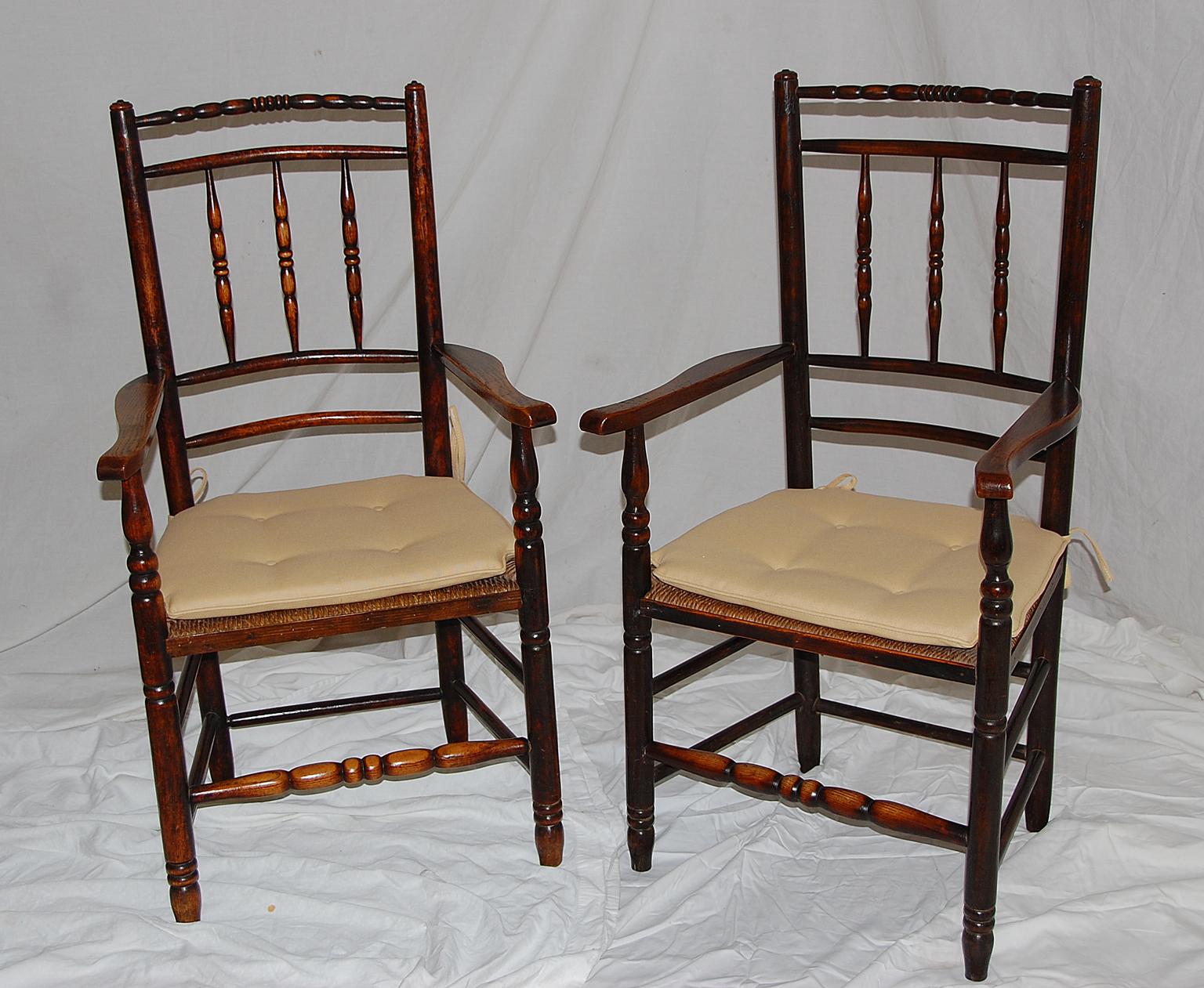 English mid-19th century set of eight Dales Lancashire spindle back dining chairs, including two arms and six side chairs. There is lovely wear to the curved top rails of these chairs, the turned double box stretchers provide strength. These chairs