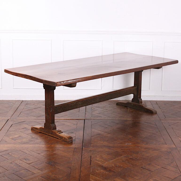 English solid oak plank-top refectory table, the two inch plank top raised on simple square supports and feet, and with a sturdy oak horizontal stretcher for added stability. Lovely colour and patina to this charming rustic table. 

