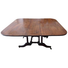 English 19th Century Stained Elm and Mahogany Drop-Leaf Table on 4 Iron Castors