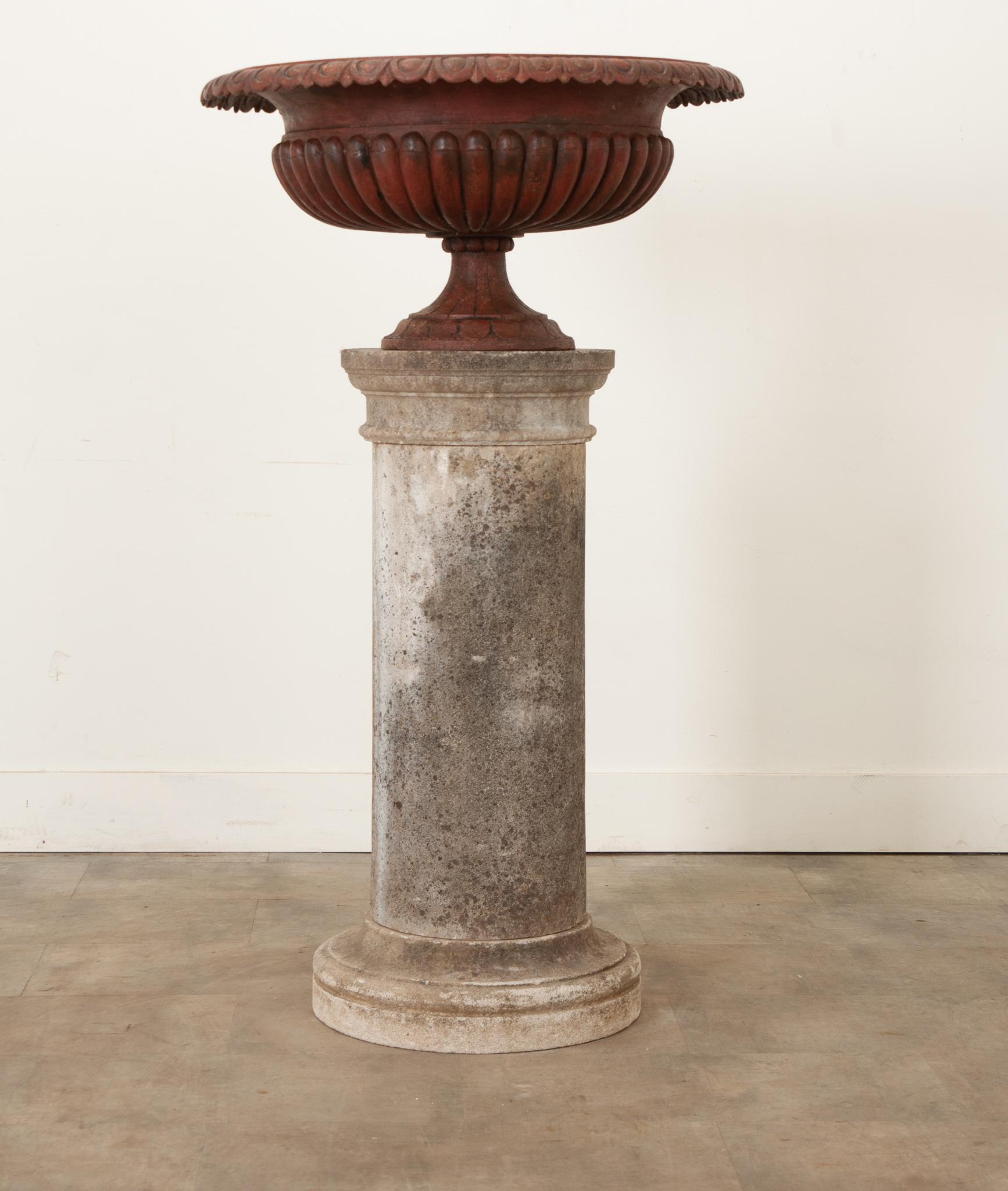 This antique urn, painted deep red, is the perfect way to add classical style to your garden. Crafted from cast iron with egg and dart motifs on its circular fluted shank and band around the concave center- it has gained a fantastic patina over the