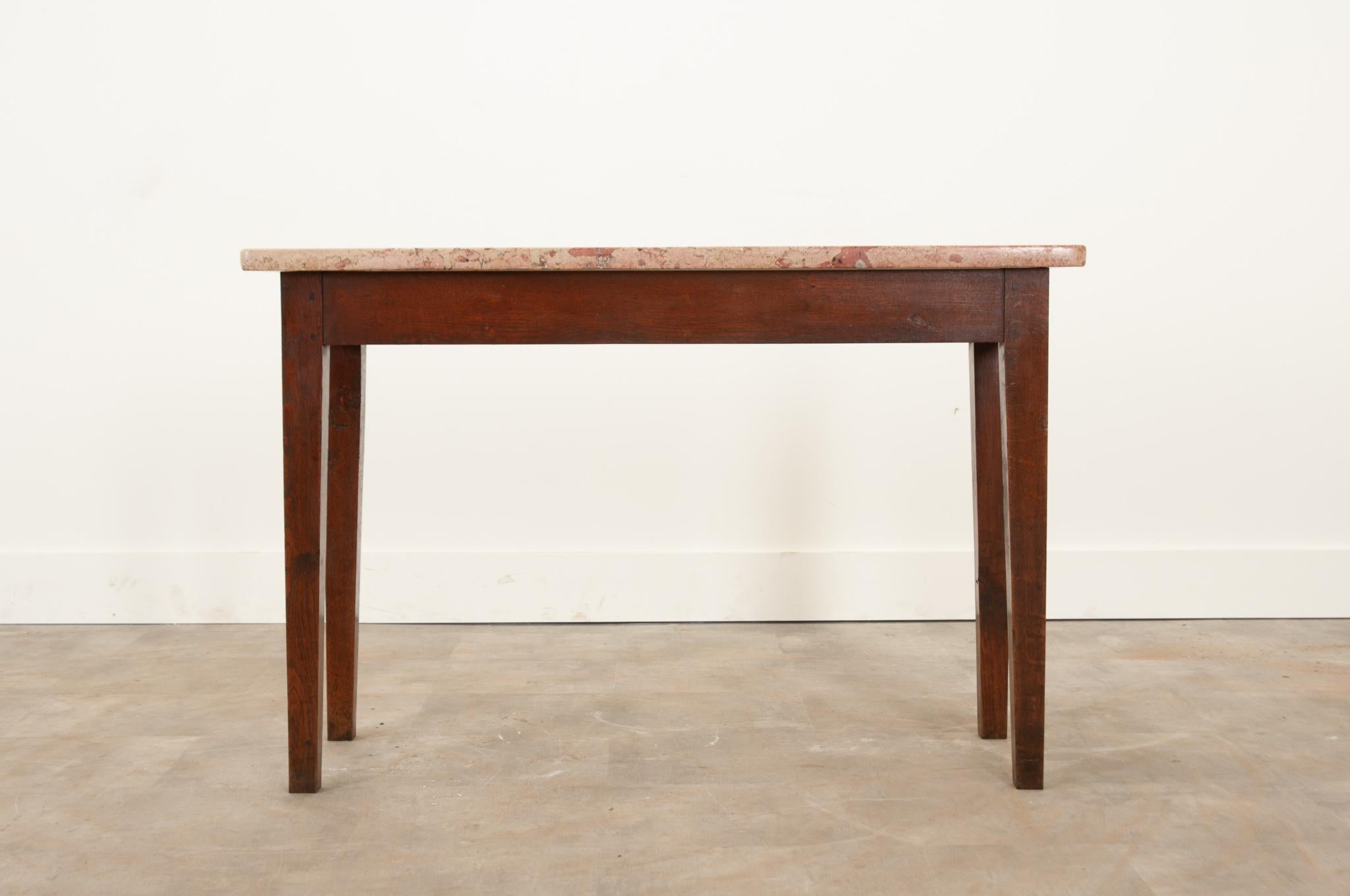 A unique and simply constructed console table, circa 1850. The gorgeous warm colored soapstone top is in wonderful antique condition and adds so much character to any space. A plain oak apron connects to slightly tapered legs with peg- in-hole