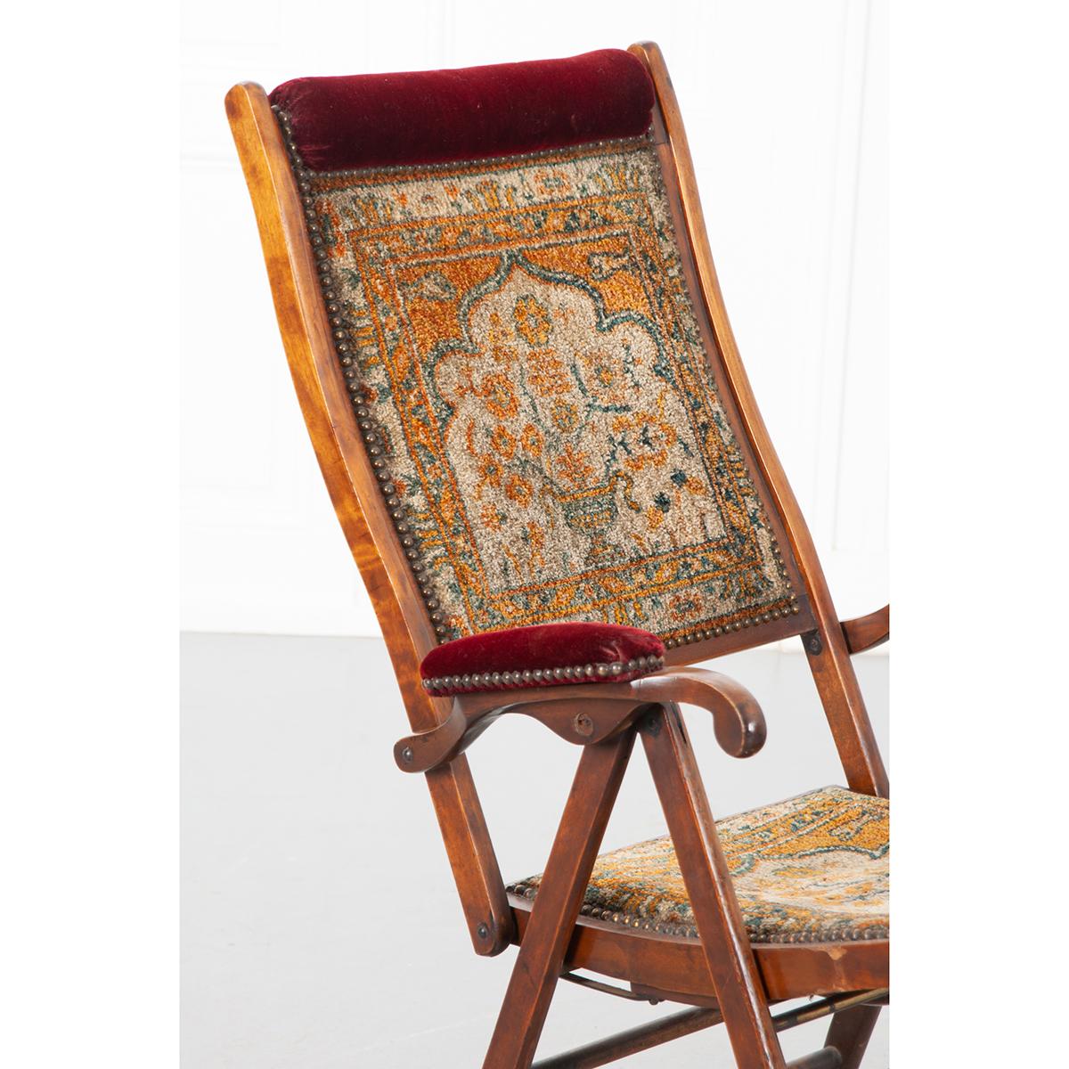 This is an English 19th century tapestry and walnut recliner. It is adjustable and also folds down so it can be easily moved or travel with the owner. It would be a conversation piece. Circa 1870. Be sure to look at the detailed images. 
Folded: