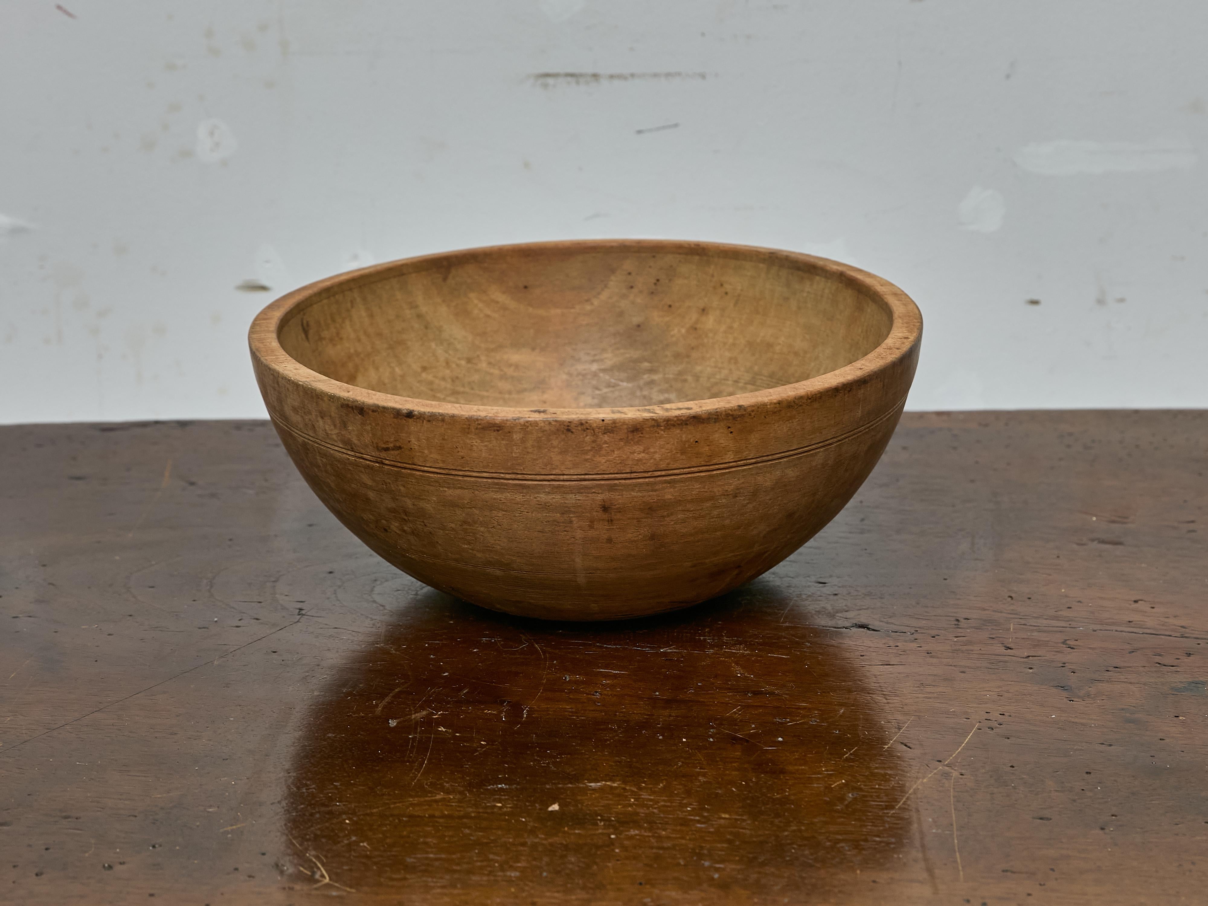 This 19th-century English bowl is finely turned from sycamore and features a softly rounded profile with a subtly tapering base. Its proportions are particularly harmonious—measuring 15 inches in diameter and standing 6.25 inches high, the bowl