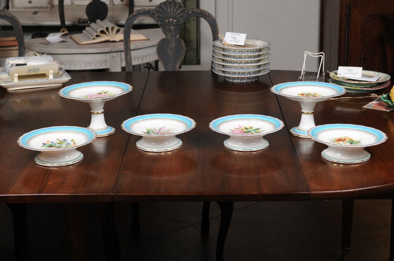 English turquoise and white faience compotes and tall plates from the 19th century, with painted floral decor, priced and sold individually. Born in England during the 19th century, each of these pieces features a turquoise border accented with gilt