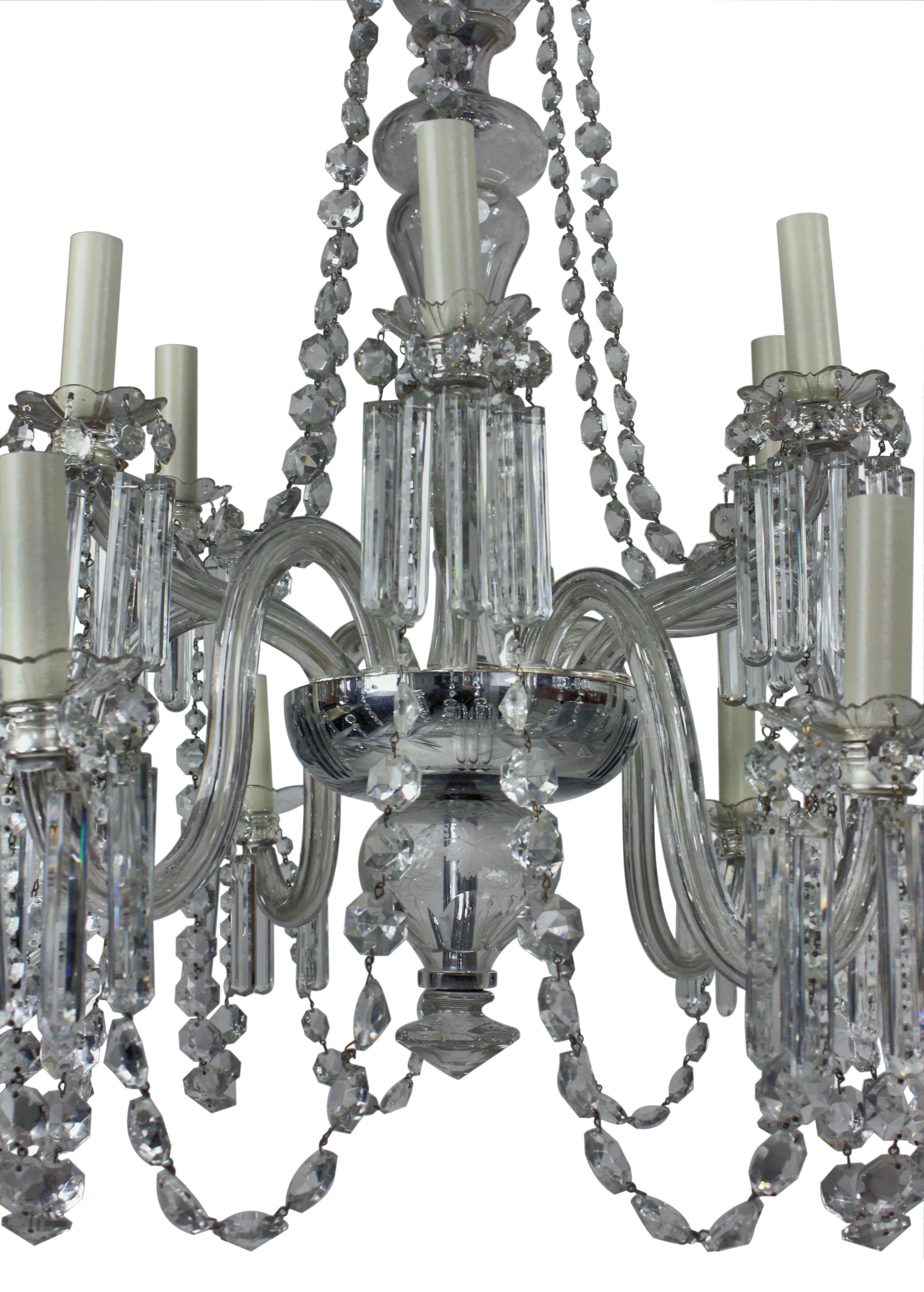Lampadario inglese del XIX secolo a dodici rami in vetro tagliato. Precedentemente era un gasolier, di ottima qualità. Il tutto è decorato con prismi, bottoni, festoni e pendenti in vetro tagliato, con un grande baldacchino appeso a festoni.