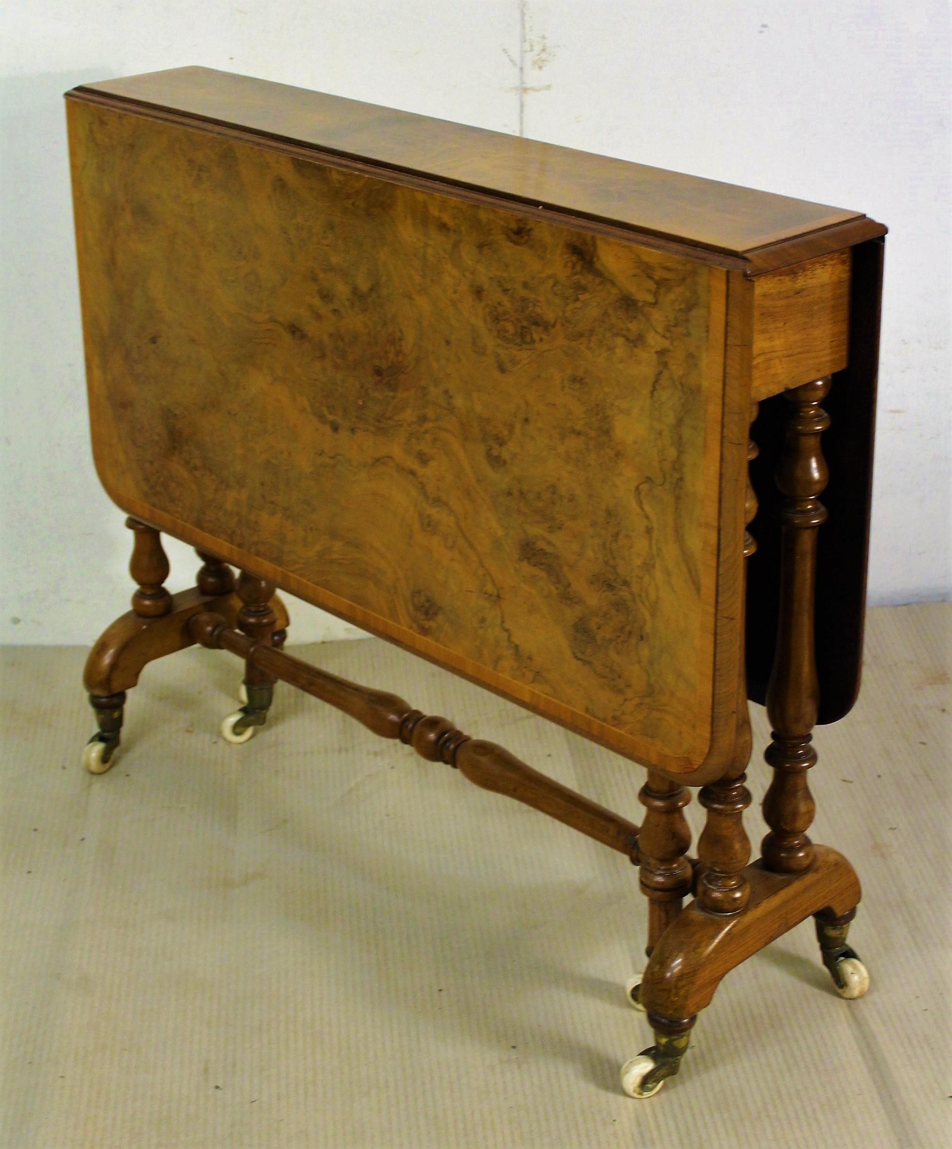 A lovely mid-Victorian period burr walnut Sutherland table. The top in burr walnut with rosewood cross banding and the legs and frame in solid walnut. With swing out legs to support the flaps when in the raised position. The legs terminate in their