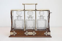 English 19th Century Victorian Locking Tantalus with Three Cut Glass Decanters