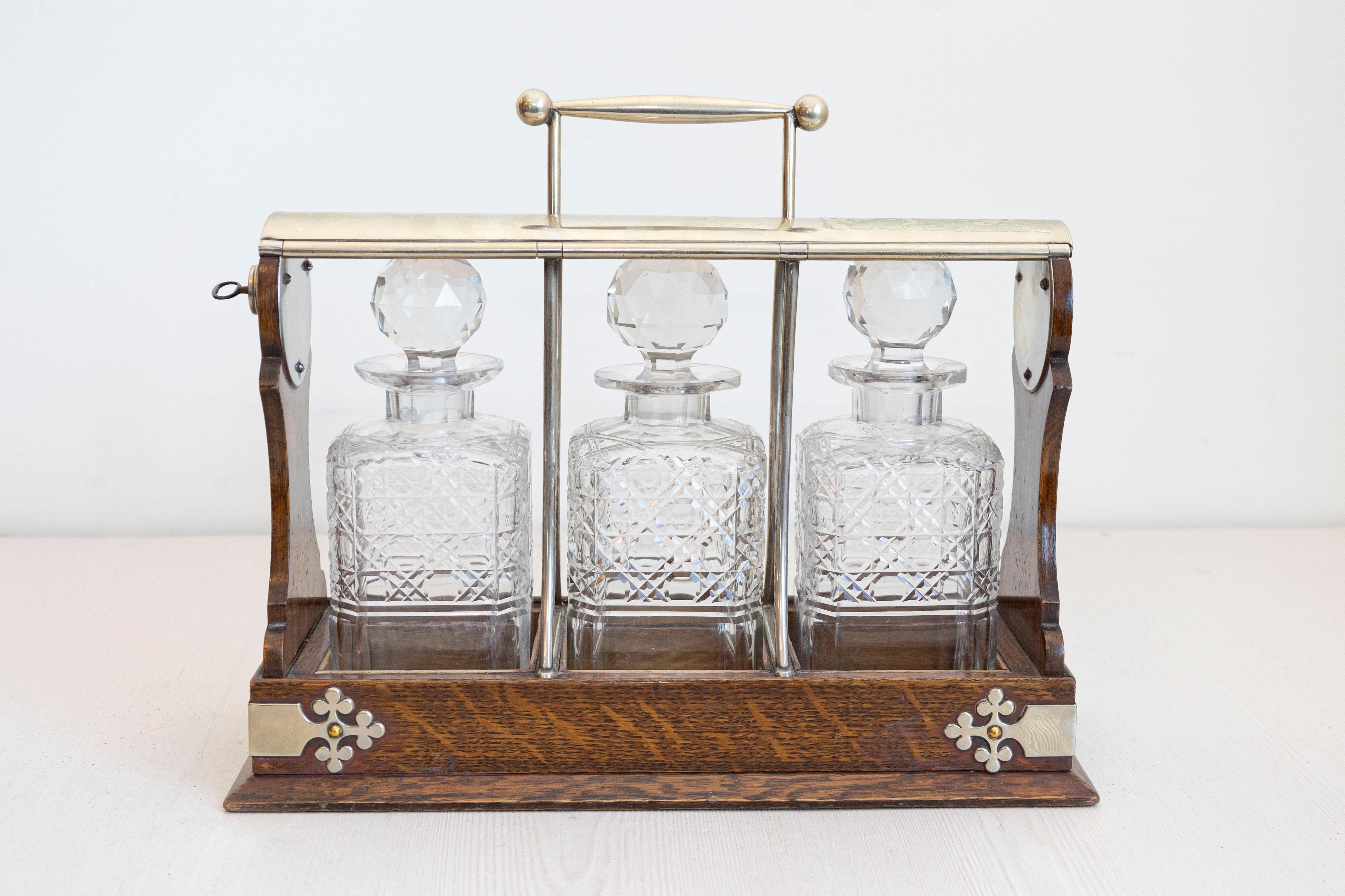 Metal English 19th Century Victorian Locking Tantalus with Three Cut Glass Decanters For Sale