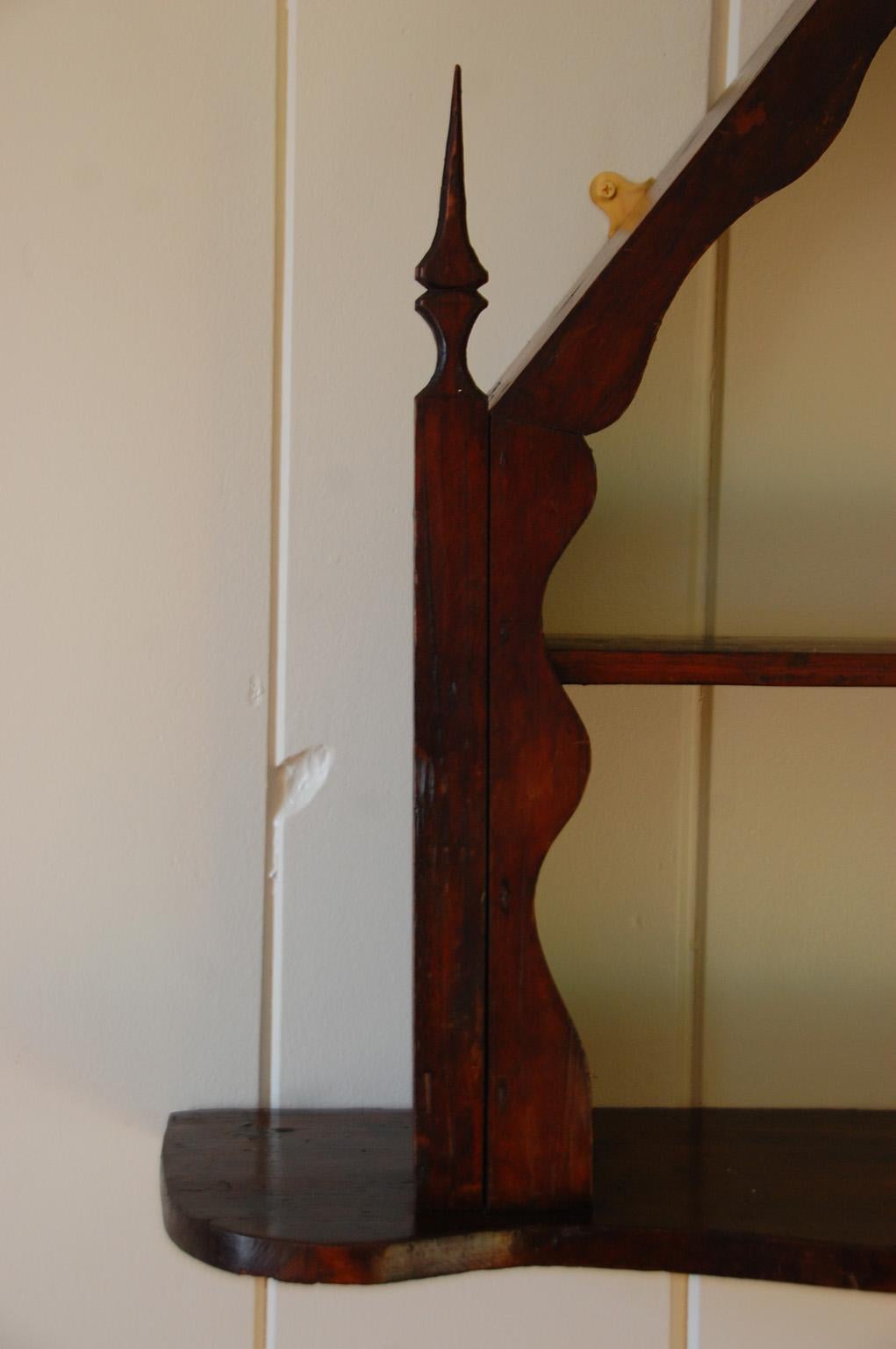 English Victorian country hanging shelf with gothic influence. This shelf was probably made by an individual who wanted to create a shelf with character for a particular spot or person. This rather naive and quirky piece used wood that was at hand,