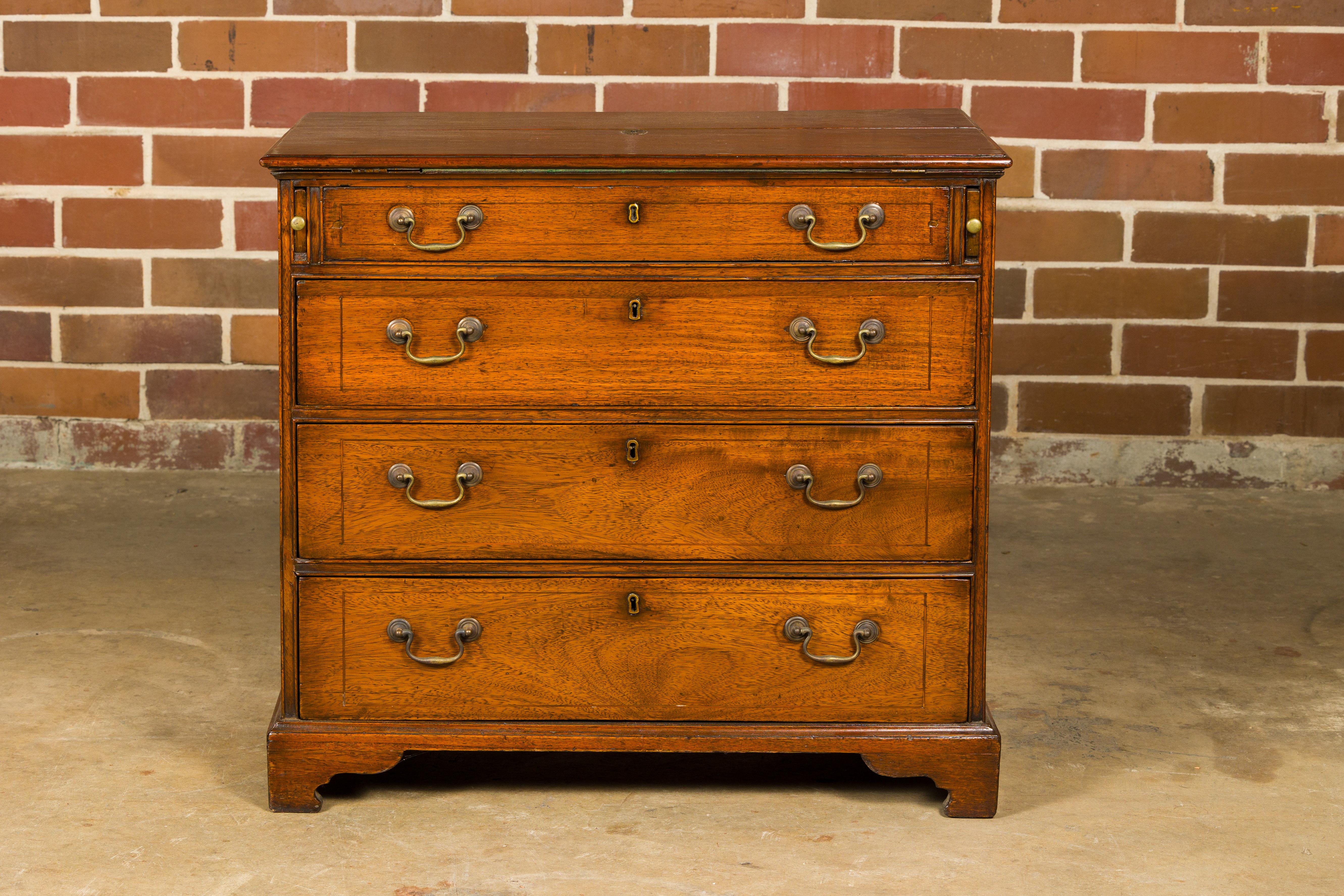 An English walnut Campaign butler's desk from the 19th century with writing area, three drawers, bracket feet and brass hardware. This 19th-century English walnut Campaign butler's desk is a remarkable fusion of functionality and classic elegance.