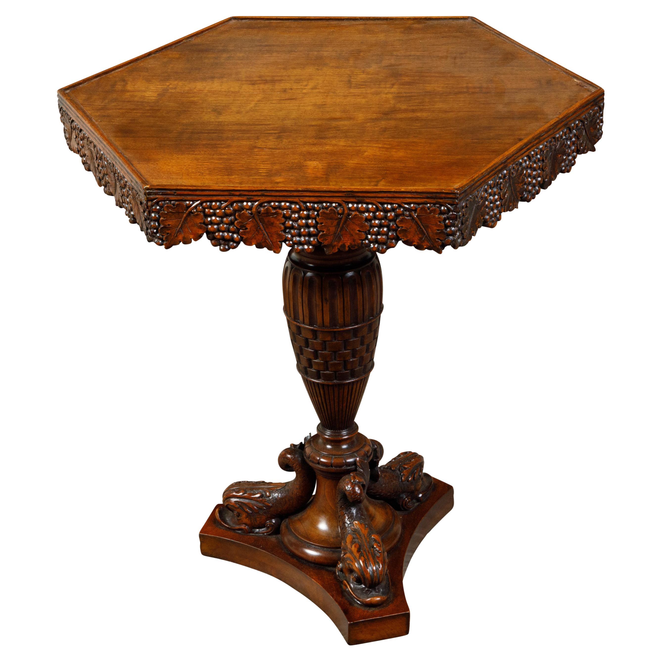 Mesa auxiliar inglesa de pedestal de nogal del siglo XIX con uvas y delfines tallados