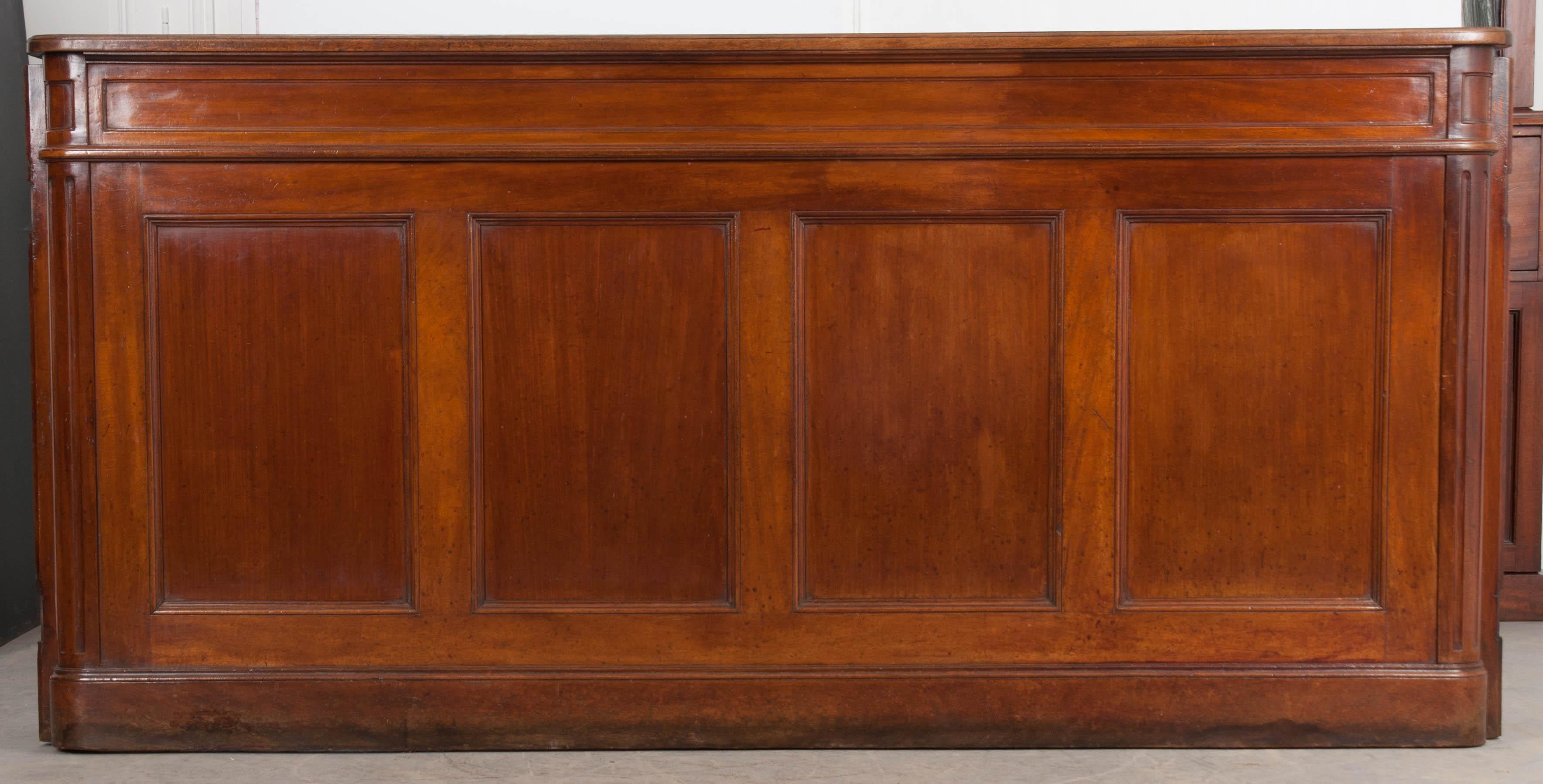 Tired of going to the bar? Bring home this English 19th century solid walnut pub-bar and you won’t have to leave the house! This spectacular piece was sourced from a pub in England and was made circa 1880. The front of the bar is styled with four