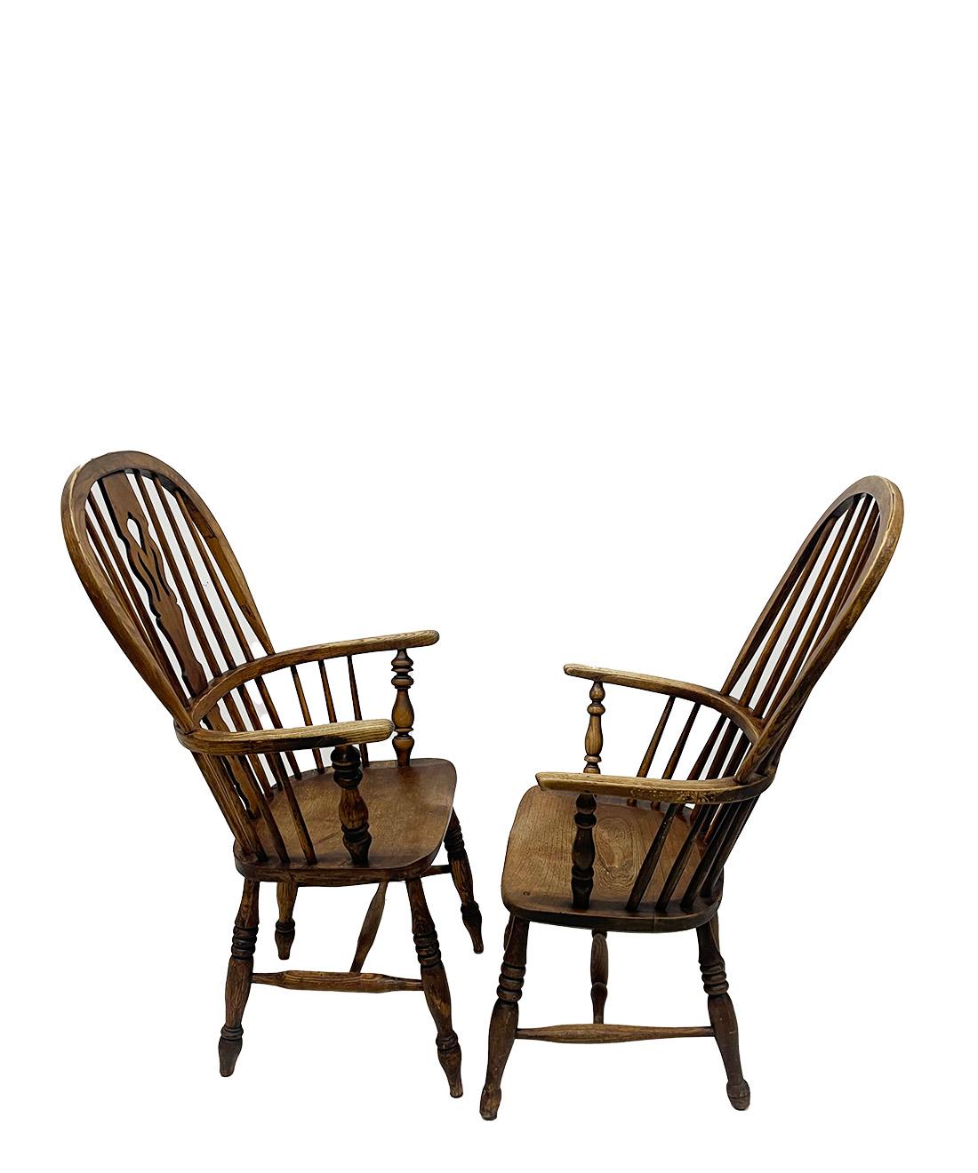 English 19th Century Windsor armchairs

A set of oak Windsor chairs with a high, rounded back with bars. The chairs with round curved armrests on 4 twisted oak wood legs with a single H connection. The seats of the chairs have a saddle-shaped seat.