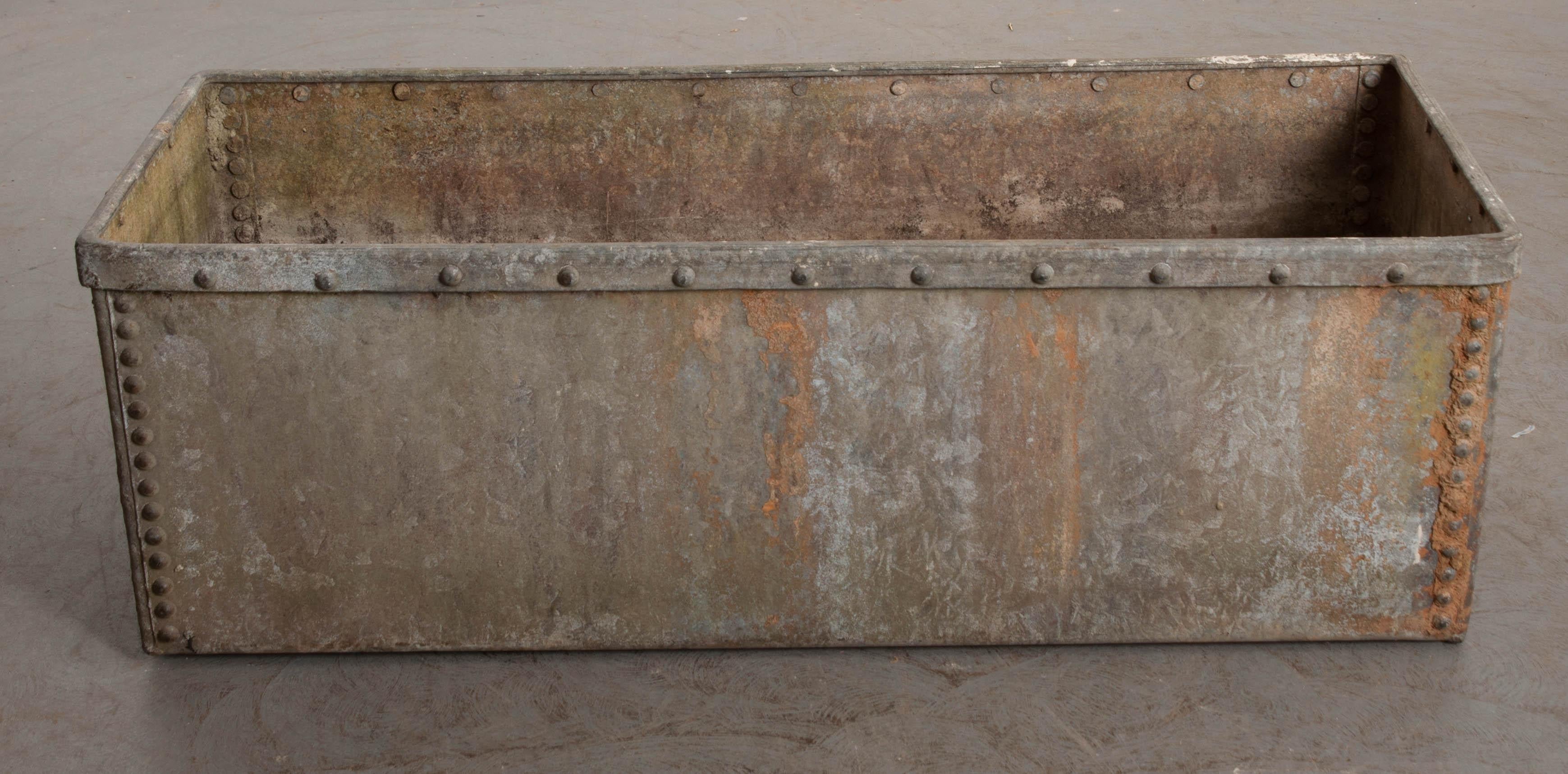 Make a big splash in your garden or outdoor space with this commanding zinc trough from 19th century England. This long and large metal receptacle would serve as a wonderful cachepot for your manicured shrubberies, topiaries or trees. It’s