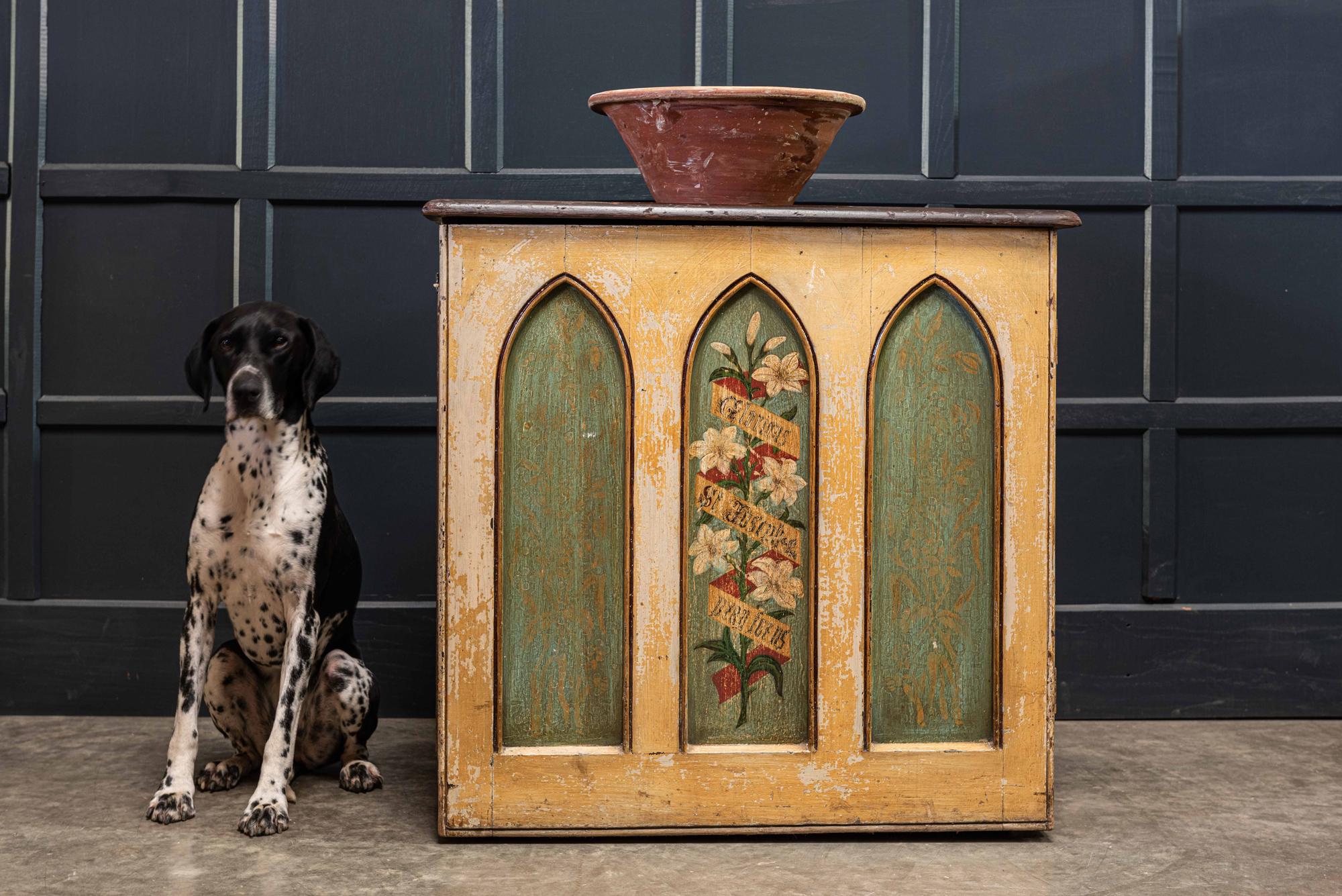 English 19th century decorative painted chapel cupboard
circa 1860.

The 3 Gothic arc panels, painted with a dark green ground and the flanking arches have faded gilding and quite a faint quatrefoil design, reminiscent of Pugin. The stand out