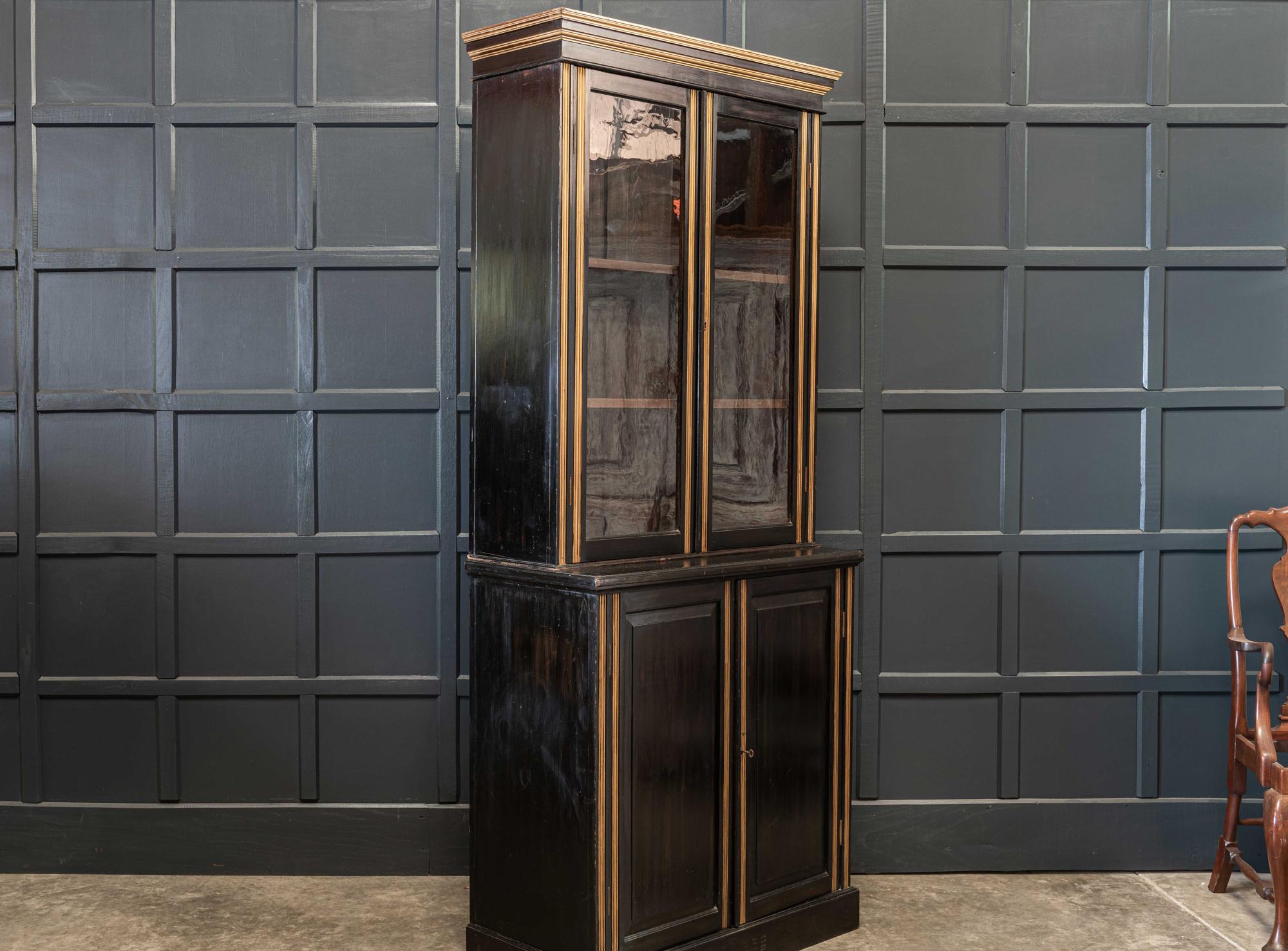 19th century English ebonized glazed bookcase with adjustable cabinet shelving. Original glass, locking key and brass locks. Three sections, great slim proportions,

circa 1850.

Measures: H 220 x W 100.5 x D 45.5cm
Cabinet D 31cm.

     