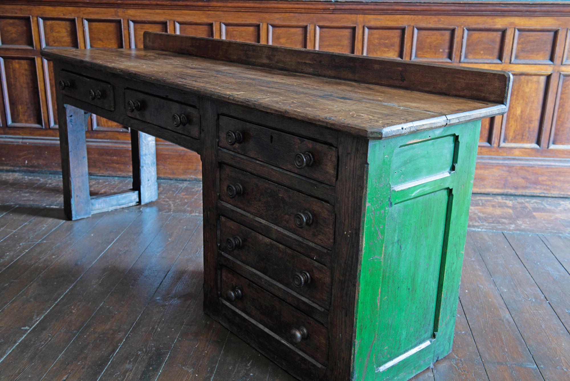English 19th century oak church prep table counter.
circa 1860.

Sourced from a church in Boston Lincolnshire

Solid oak prep table counter with six dovetailed drawers. A lovely color with the original paint to one end and prep cut marks in the