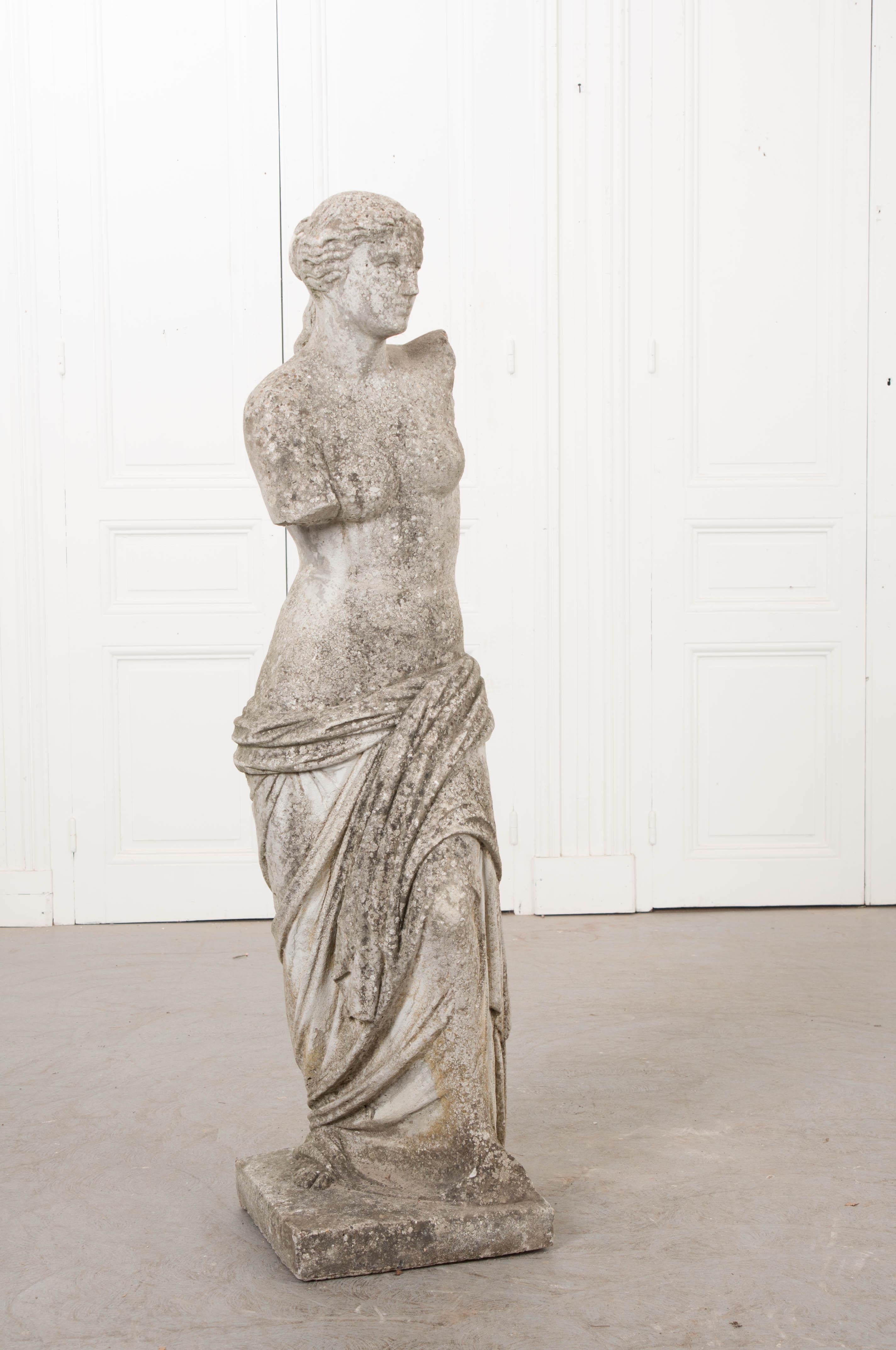 This carved stone statue of Venus de Milo, circa 1920, was found in England and modeled after the original which was thought to be Aphrodite, the Greek goddess of love and beauty. She will certainly add a classical touch to any garden and would be