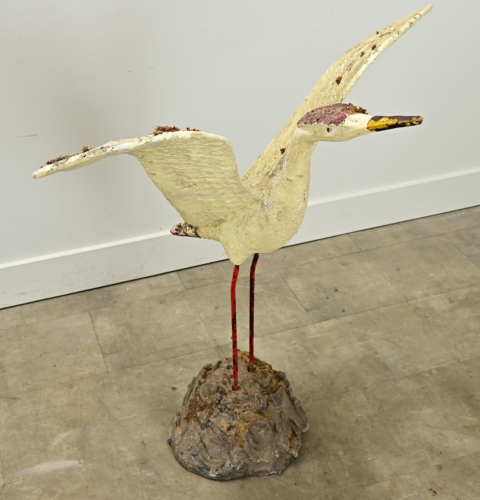 This whimsical English statue of a hand painted egret with its wings spread is ready to fly across the skies. This bird-in-flight is the perfect addition to your interior or outside garden. The egret and its base is made of reconstituted stone and