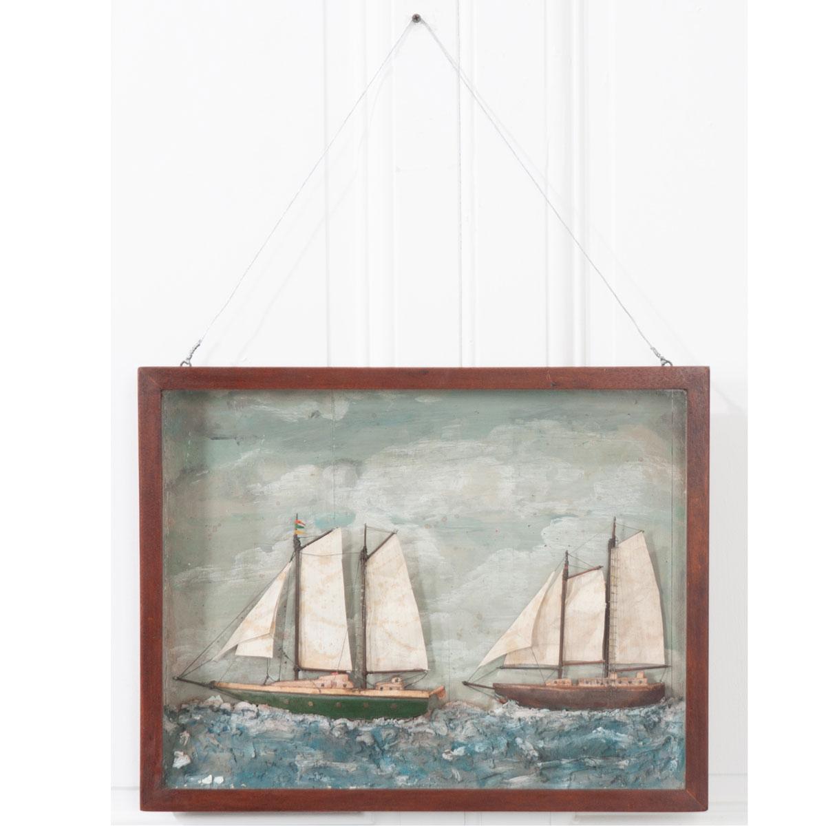 A brilliant English, 20th century nautically themed diorama featuring two schooners in a stained wood, framed box, c. 1920. These three-dimensional works of art were typically made by sailors. Note the meticulously detailed sails, masts, ropes,