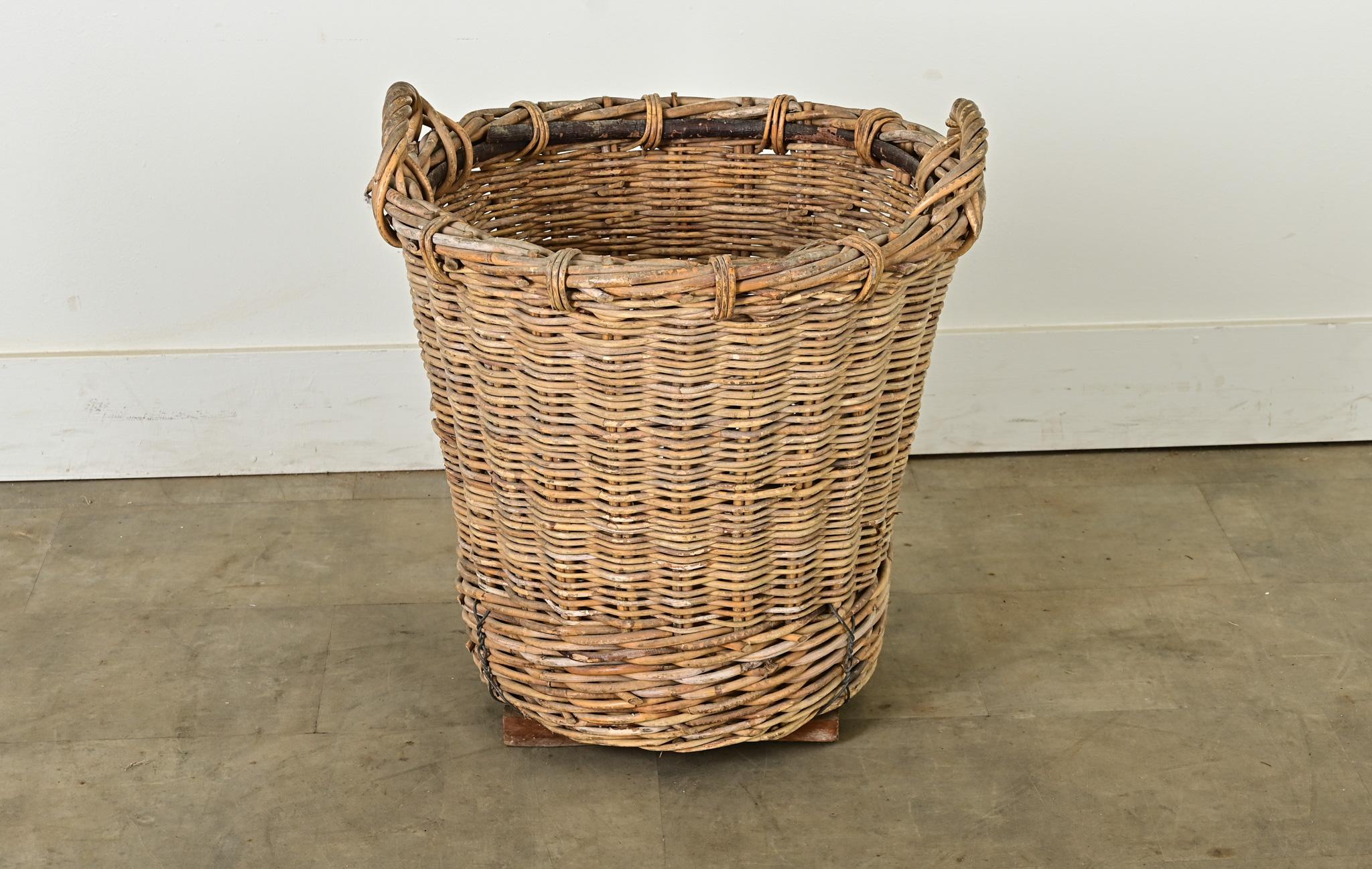 A charming English harvest basket from the latter part of the 19th century, circa 1890. This sturdy basket was made to stand the test of time. Originally used to collect fruits, vegetables and other crops, today it would make a delightful knitting