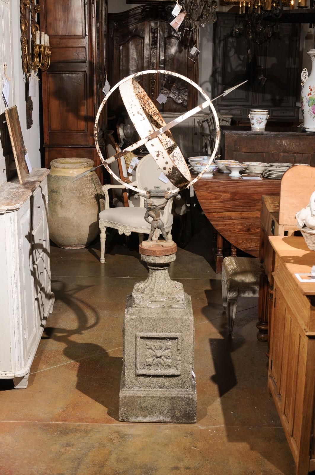 English 20th Century Iron Armillary Held by the Titan Atlas on Stone Pedestal In Good Condition For Sale In Atlanta, GA