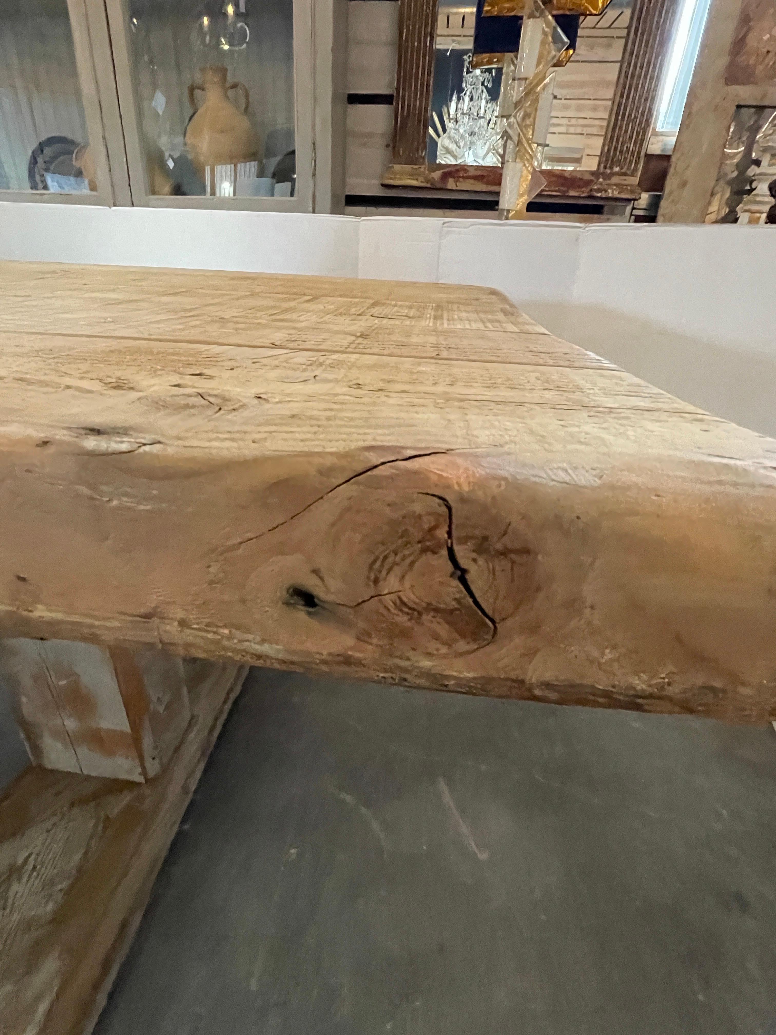 This is a massive pine table that's 13 feet long made from 300 year old columns from England.  The wood top is about 3' thick and the knotting is beautiful throughout the table. It's base is lightly painted a french blue that shows much of the