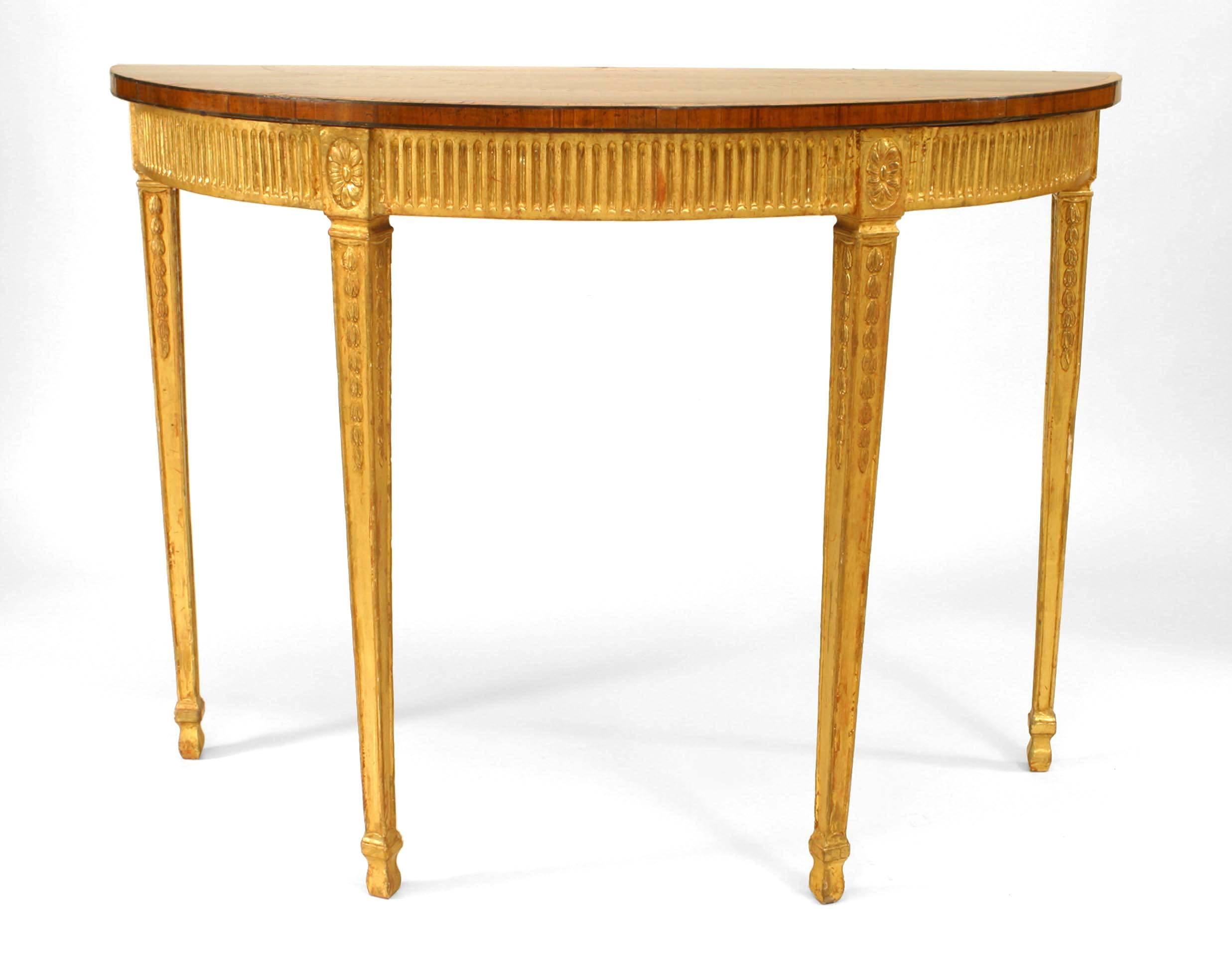 English Adam-style (18/19th Century) gilt half round console table with fluted design apron with a satinwood and various wood inlaid top.
