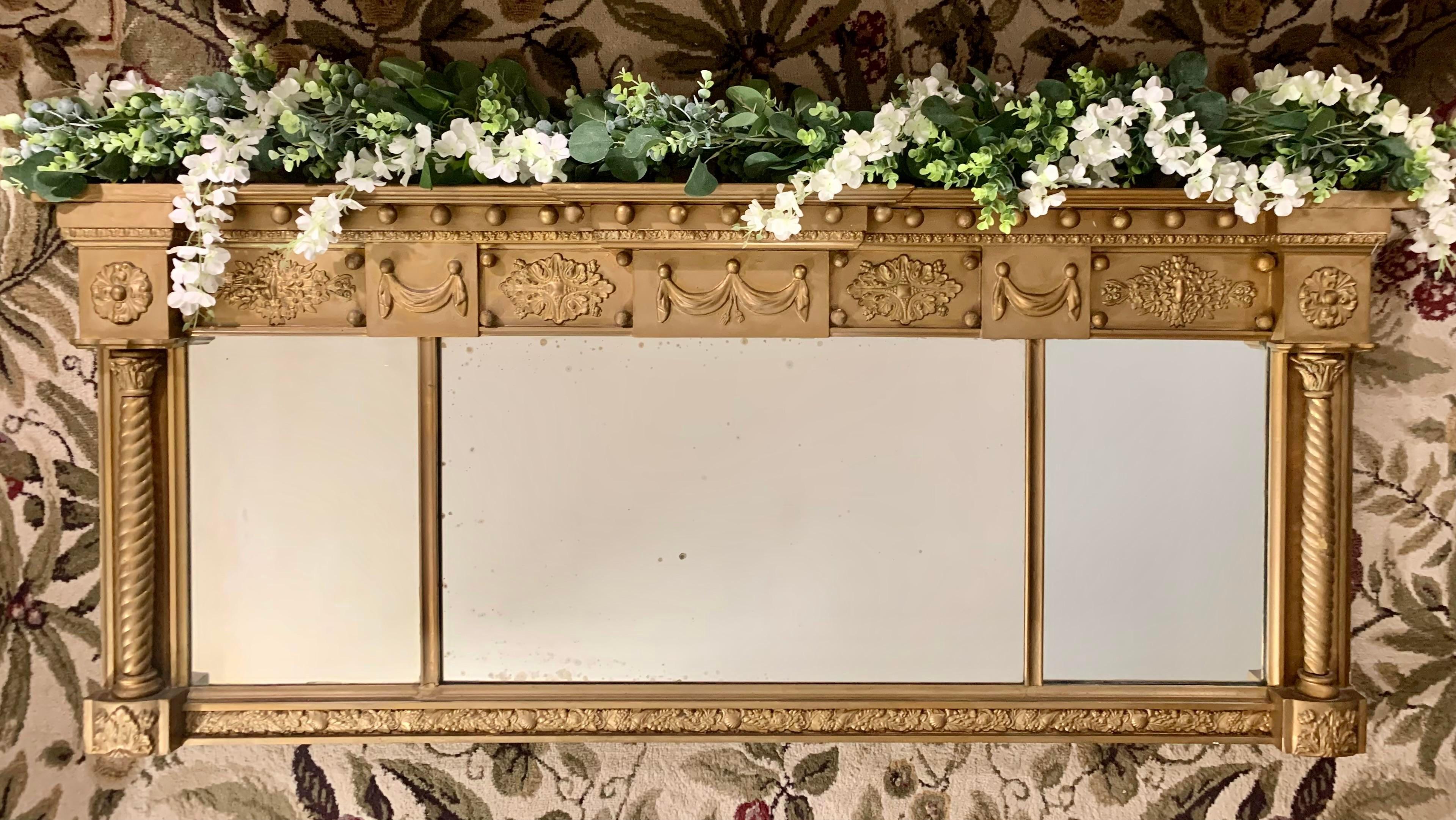 Made in England, circa 1820, this antique triple panel overmantel mirror with individualized mirror plates and exquisite polychrome giltwood carved and cast detail, is prepared to make an elegant, historical statement in your home.

Originally
