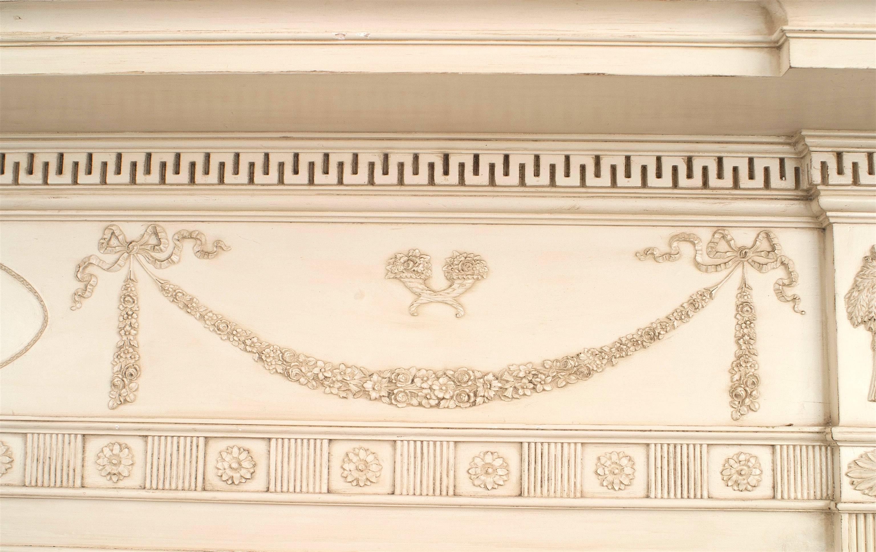English Adam-style (1920s) white painted wood fireplace mantel with carved swag and tassel relief.
