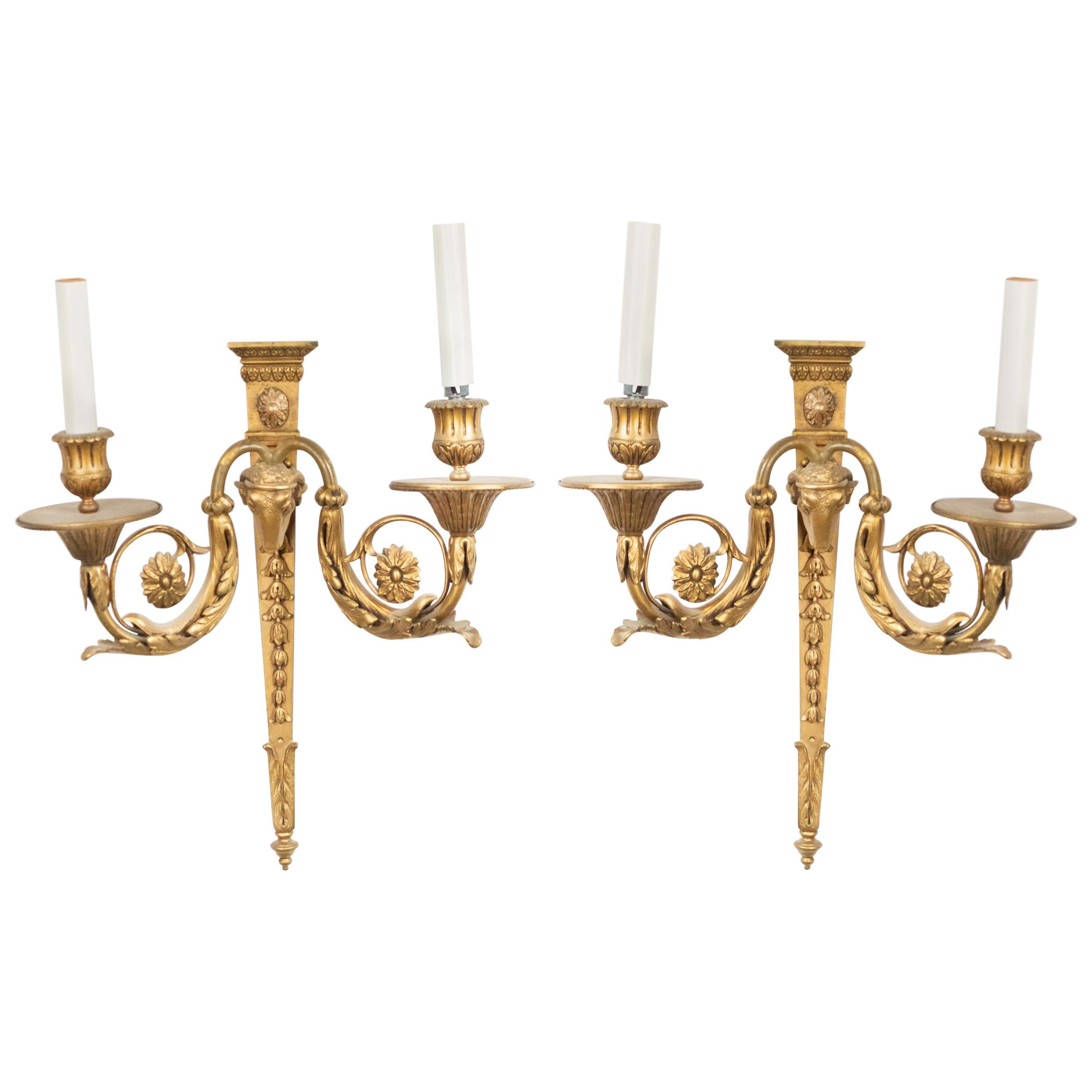 Pair of English Adam-style (19/20th Century) bronze dore wall sconces with two scroll arms and ram's head design. (PRICED AS Pair)
