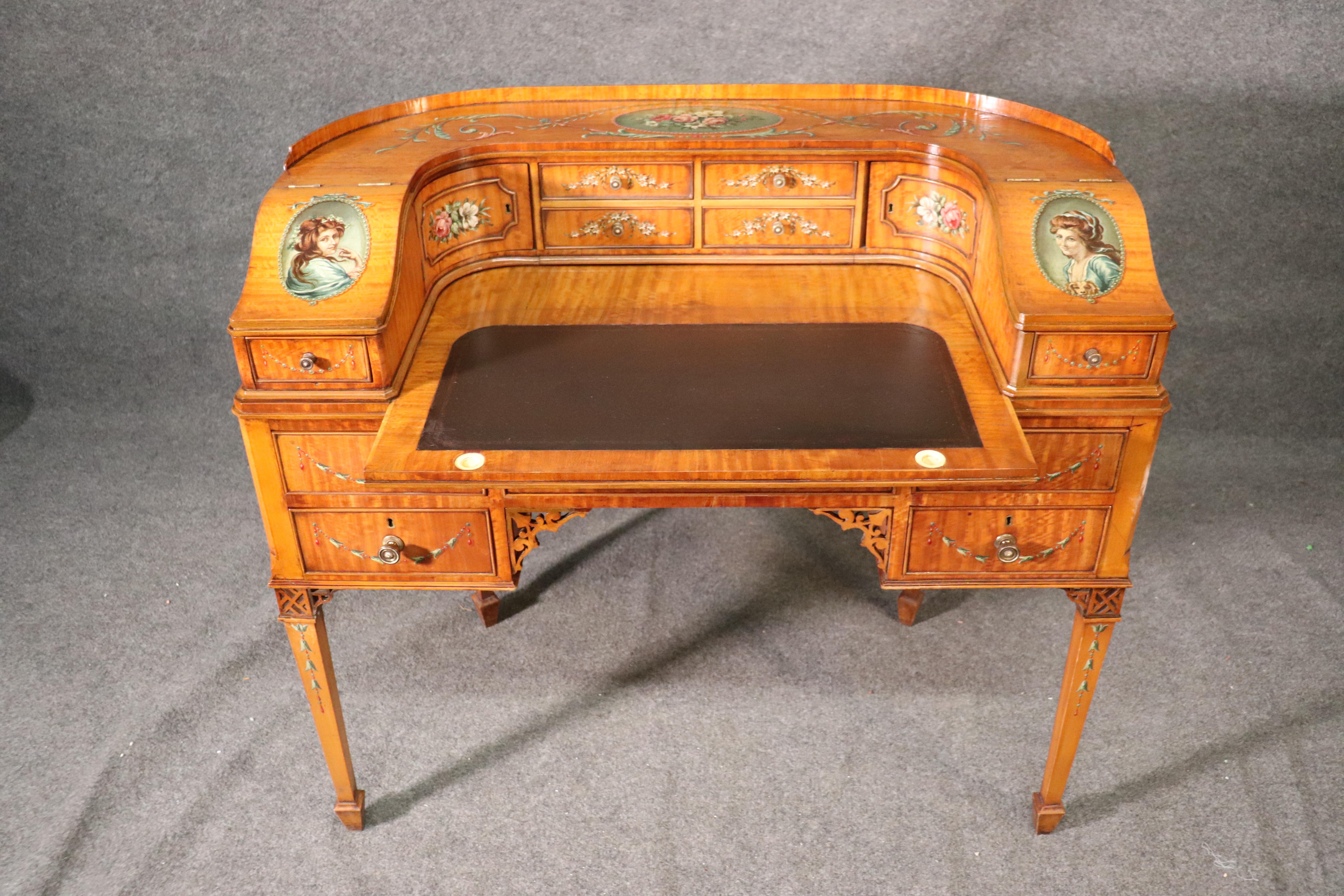 This is a beautiful hand painted satinwood early 1900s era desk. The desk is in good vintage antique condition. The desk measures: 42 wide x 37 tall x 22 deep.