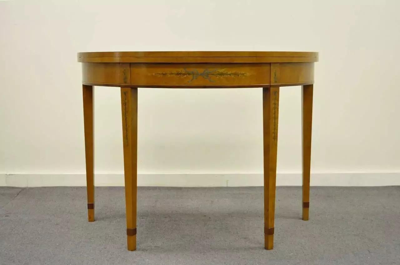 English Adams Style Hand Painted Leather Flip Top Demilune Console Game Table. Item features delicately painted floral motifs on the skirt and legs, very nice natural wood grain, and a banded and tooled leather top when opened. Very high quality