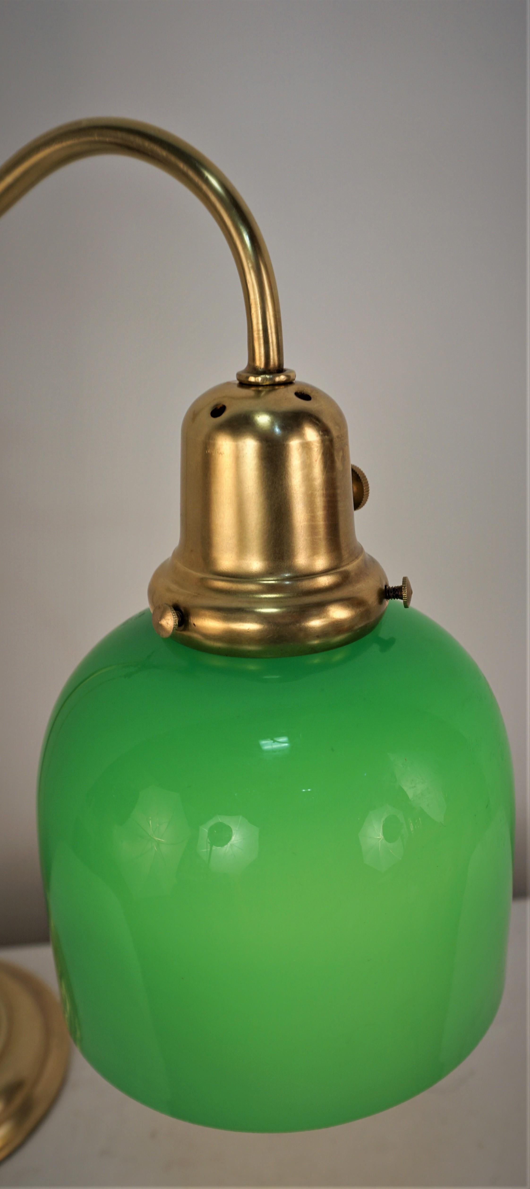 Early 20th adjustable height brass and green case glass desk or table lamp.