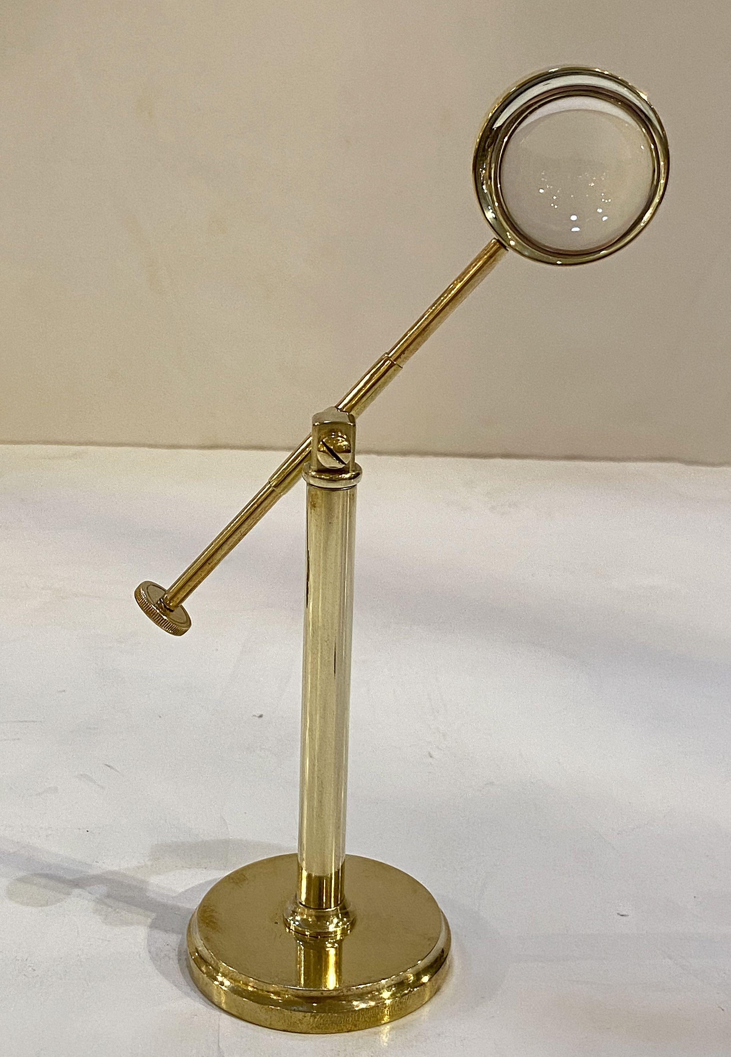 A fine English desktop or tabletop magnifier of brass in the Classic industrial style, featuring a magnifier on an adjustable stand which allows movement up and down, side to side, and rotational.

Stand H is approximately 5 1/2 inches with