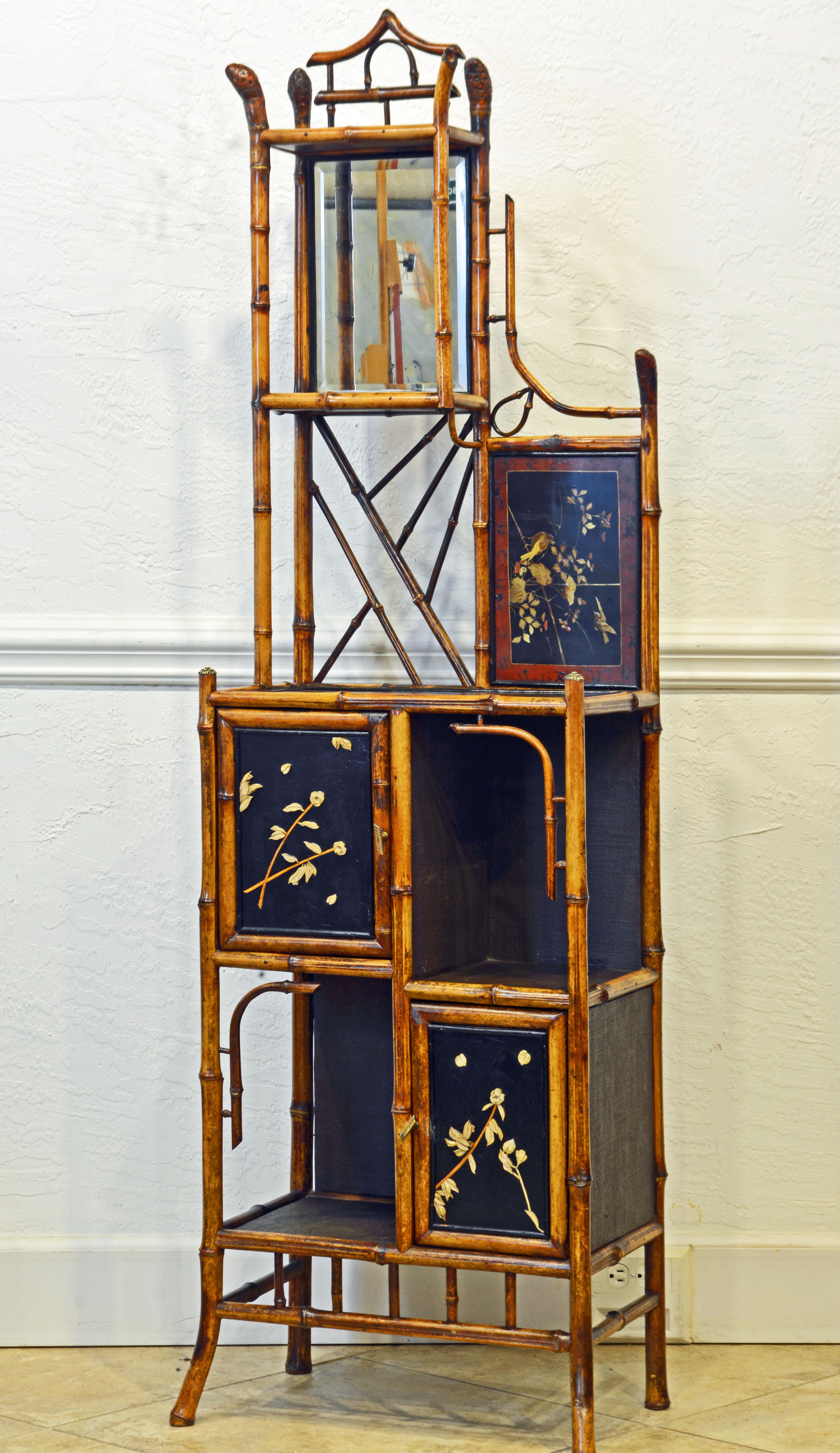 This artful English bamboo and decorated lacquer cabinet étagère combines traditional chinoiserie style with the trends of the late 19th century new ideas of the Aesthetic Movement. It consists of a bamboo framework offering cabinets with decorated