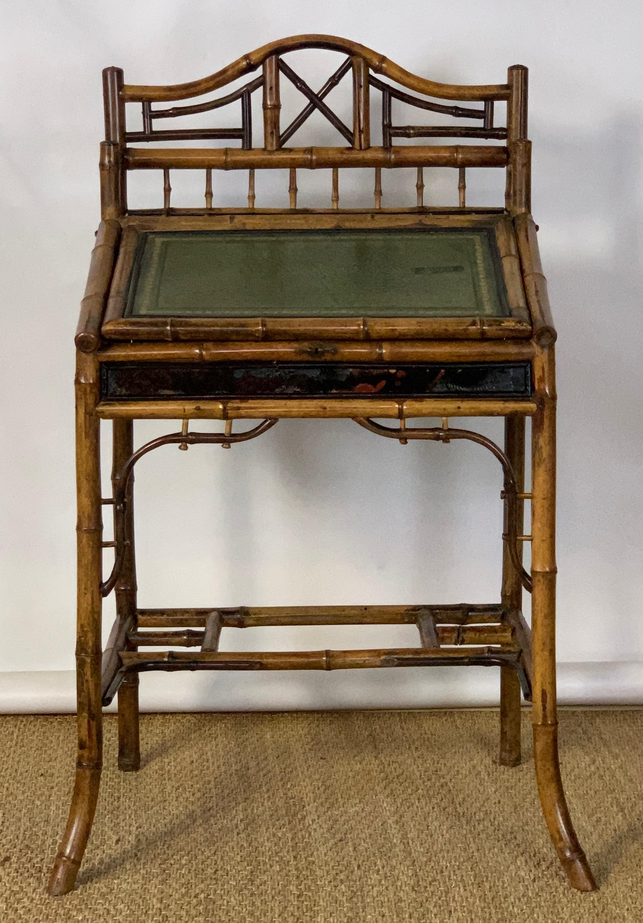 A small and exceptionally charming English late Victorian tortoised bamboo and lacquer writing desk with inset tooled leather slanted and hinged writing surface opening to reveal a storage compartment.