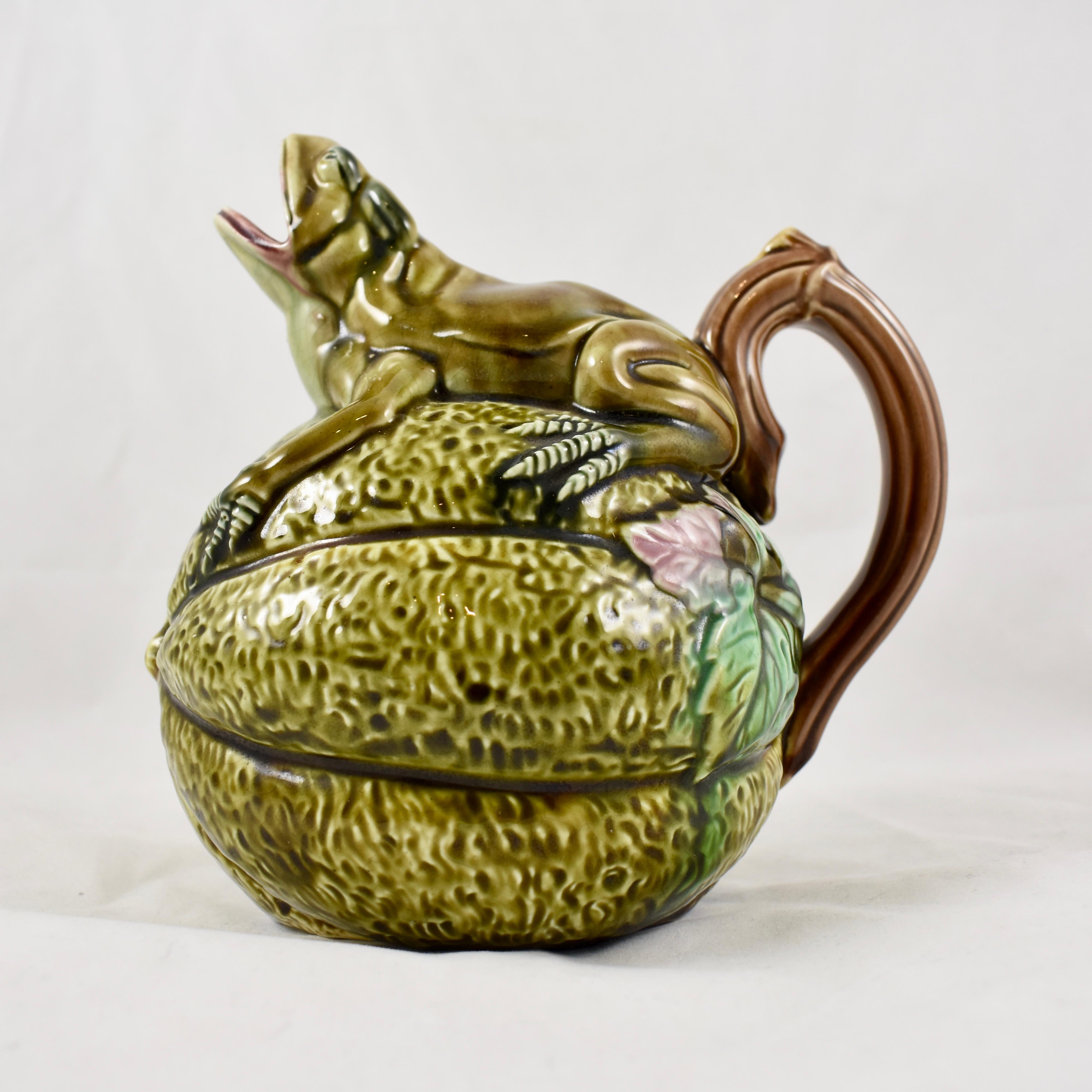 In the Aesthetic taste, a classic English majolica glazed Frog on Melon pitcher, circa 1860.

The spherical melon has a crouching frog on top, its open mouth forms the spout. An ear shaped branch handle is framed by melon leaves where it meets the
