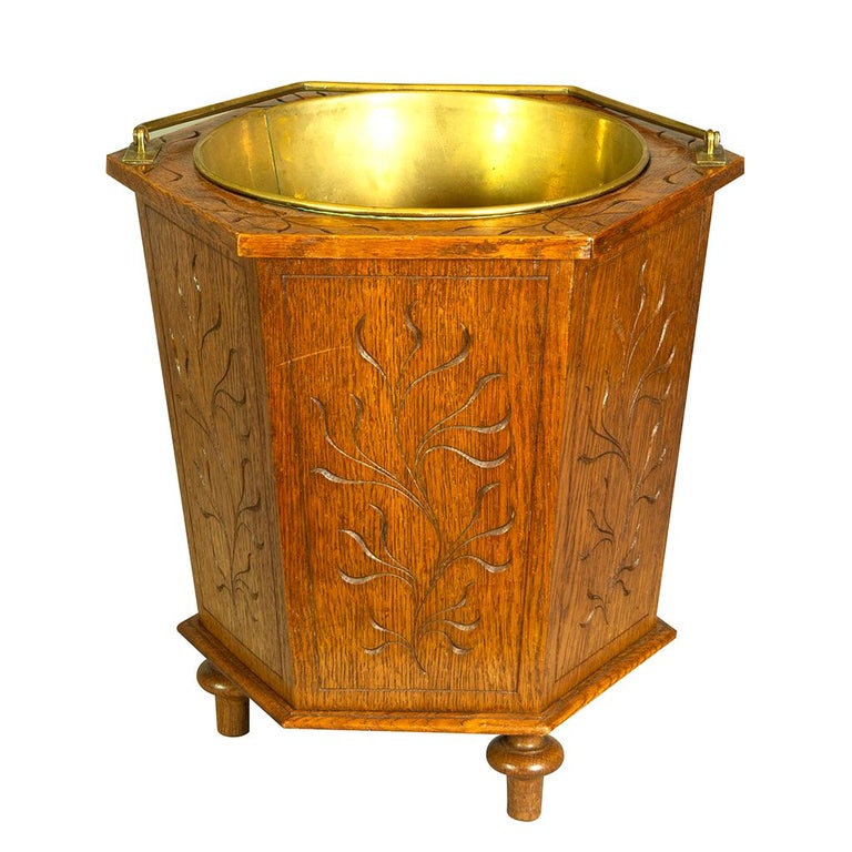 With brass handle and liner. Hexagonal form with incised carved decoration. Toupie feet.