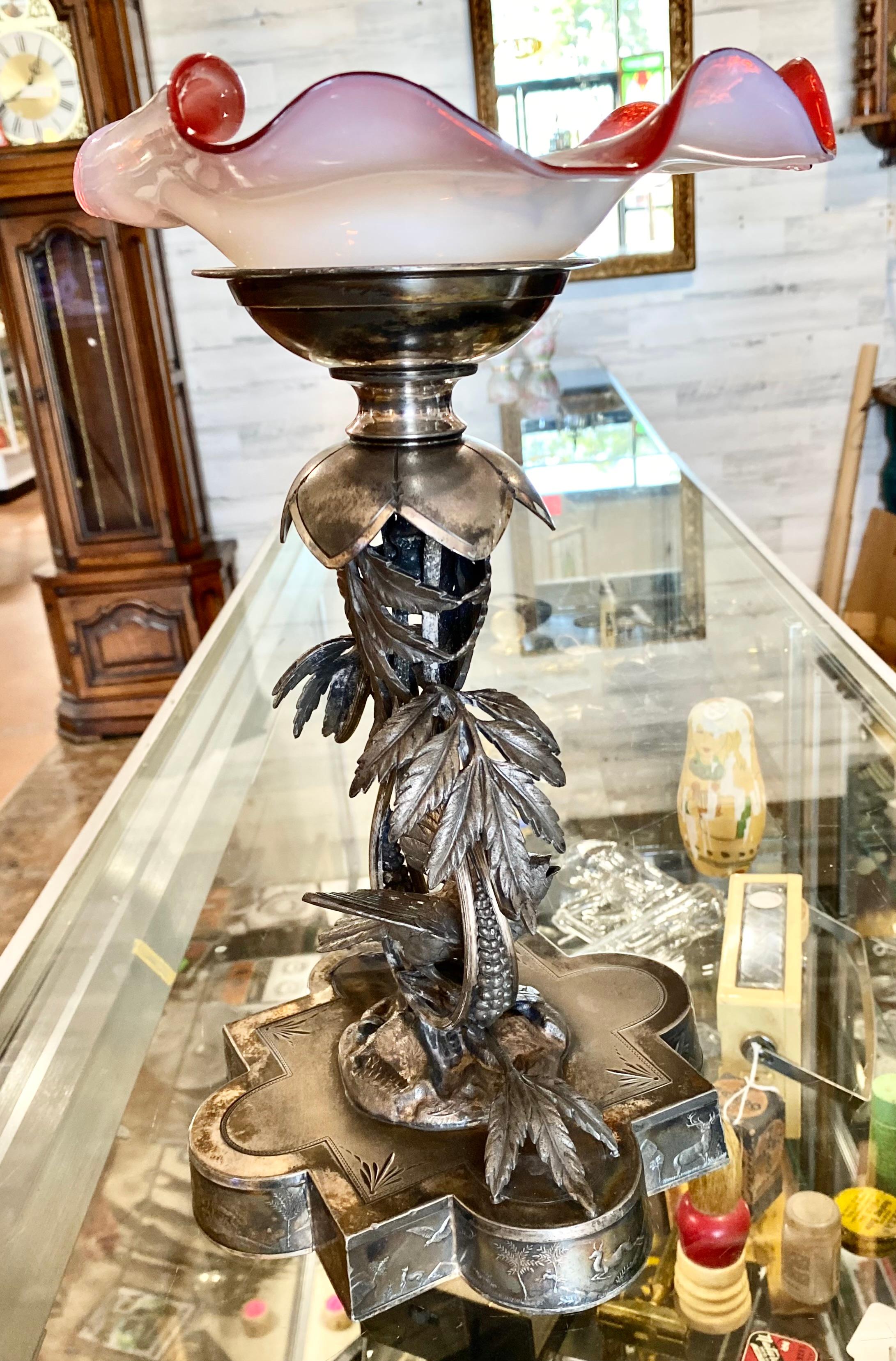 Stunning and unusual, rare English Aesthetic period silver plate and hand blown, hand painted with bell flowers, glass bridal bowl, having a perching bird with open beak under a canopy of leaves and sitting on a rocky outcropping on a shaped base