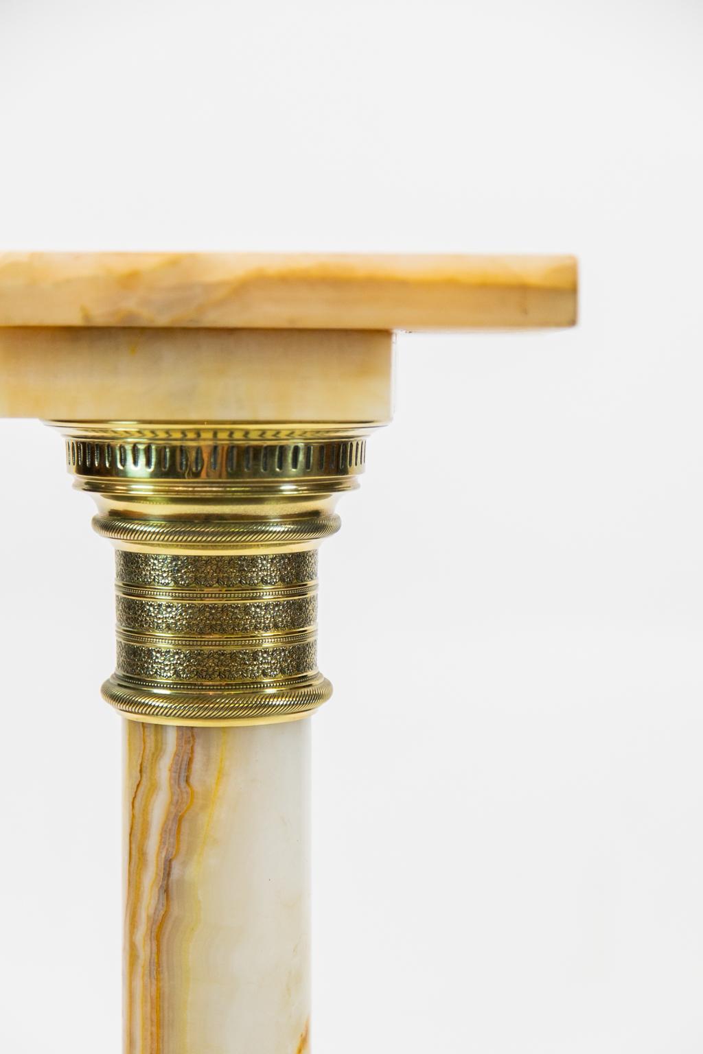 English Alabaster pedestal, with the column having cast brass capital and the base with cast brass molding surrounding the foot.
  