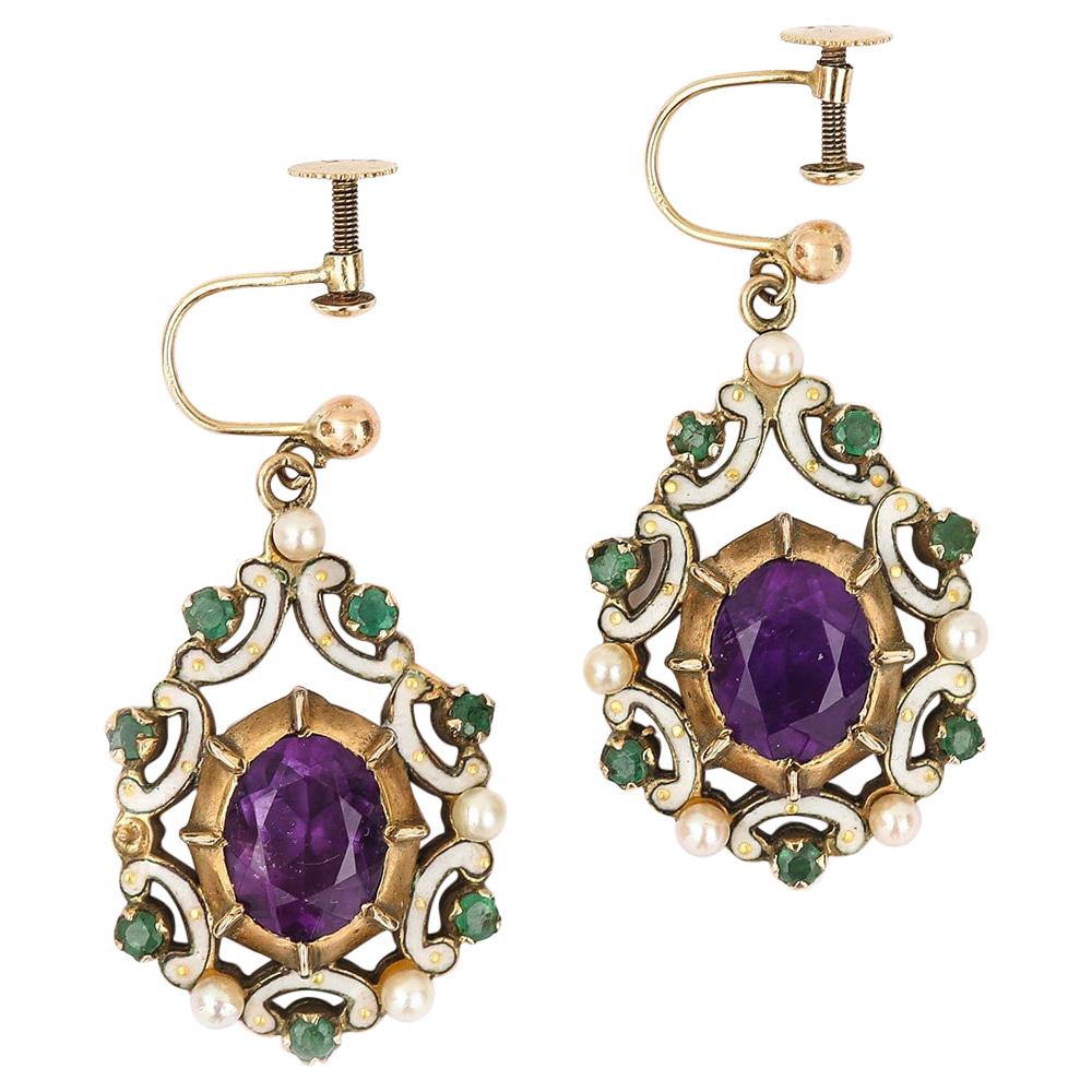 A striking and distinctive pair of vintage 9 karat yellow gold amethyst, emerald, pearl and enamel earrings which were manufactured in London, England in 1970. Demonstrating the traditional purple, green and white colours of the Suffragette